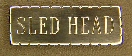 Thanks for this dedicated website! I've read about your making of custom jewelry from SR-71 parts, and I'd like to know if you could make a pin that spells out “SLED HEAD” for me. Please let me know if this is do-able, and, if you would be so kind, I'd like to get a rough idea of how much a one-off item like this will set me back. I was a Sled Head long before I knew the term existed. I've been quite interested in that amazing bird since I first heard about her in 1968 or so. I must've been in junior high when the seemingly 'double-booms' happened, and we all got a huge kick out of the noise---made the windows rattle in that old school building. We theorized it was 2 jets breaking the proverbial sound barrier close together (what did we know). A cousin who was a 2-star hinted around as to the source of that unusual 'double.' Eventually, I acquired photos and a bit of info. Been fascinated with that aircraft ever since. In the mid 1990s, I was in Iowa for an internship in compounding pharmacy, and I wanted to go to the SAC base near Omaha to see the SR-71 that was supposed to be there in their museum. Turns out the museum was locked up pending the arrival of funds to build the new SAC museum near Aurora, Nebraska. Nevertheless I persisted, and eventually I was allowed in to where the SR-71 was stored. Eeee gads! It was as though they had her in someone's back yard: she was out in the weather, resting just on her own tires in the hard-packed dirt, with WEEDS growing up around her! Tragic. Still, it was a heart-stopping thrill to see a Blackbird up close & personal. And, now that I'm a docent at the Seattle Museum of Flight, I get to talk about the Blackbird 'family of aircraft' to other soon-to-be- Sled Heads every week ---yeeee haw!! Once a year (between Christmas and New Years' Day) we have 'Blackbird Tip-to-Tail Tours' wherein, twice daily, my fellow docents and I competitively take turns giving one-hour (ok, they usually go on for at least TWO hours; but they're officially one hour) tours of this miraculous superemminent aircraft. How delightful it is to be required to study up on her, and to be quizzed unmercifully about her! So, naturally, I attend (with great enthusiasm) Brian Shul's annual presentations at the Museum of Flight---it's a joy and a pleasure each and every time I have the privilege of hearing him speak! And I have the pleasure of owning, reading, and enjoying his eye-popping informative books about this stunner of an aircraft. Criminey, I'm running out of superlatives, so will sign off for now. Dan, those are gorgeous! You talented genius you! BOTH pins are truly beautiful!! And I'll take 'em both please. Thanks once again for these amazing pins. And thanks, especially, for your (continuing) service to our Country! All the Best to Dan, Katie Wasem, SLED HEAD