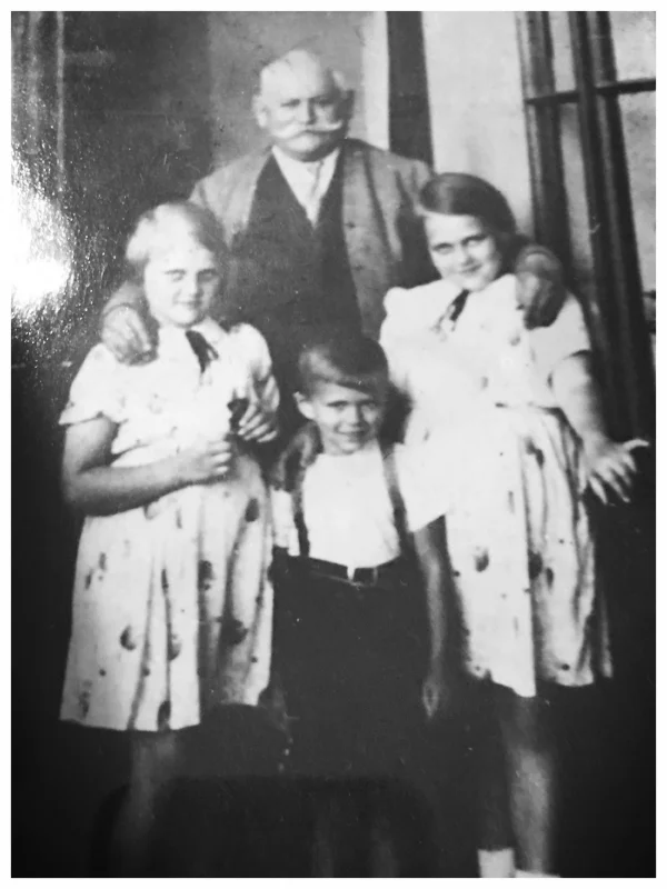 My mother (left), her younger brother and older sister with their father. 1939