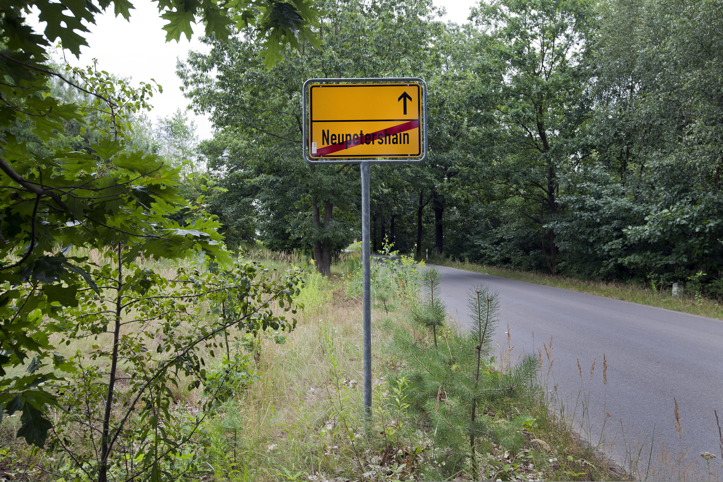 ROAD SIGN AT NEUPETERSHAIN ON THE EDGE OF THE OPEN-STRIP MINE.