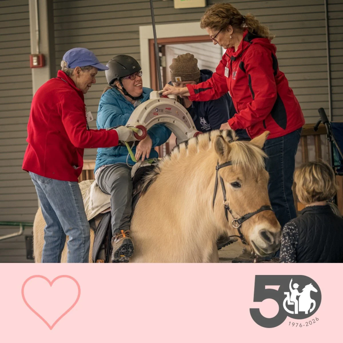 Participant is assisted by staff as they are safely mounted onto a horse using a lift system.