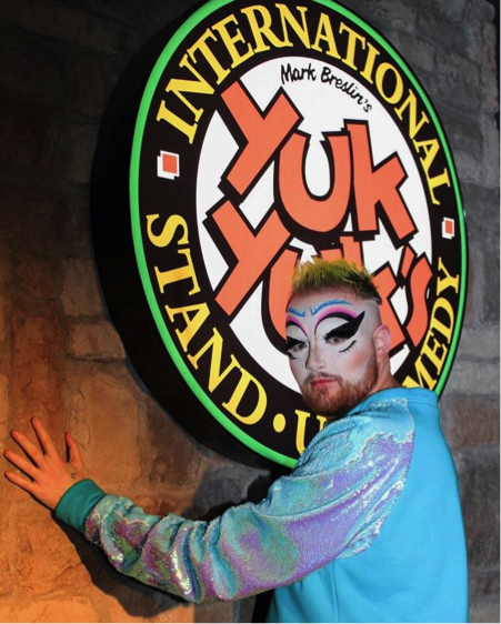 Dust in front of the Yuk Yuk’s sign to advertise the Yuk it Up Sis: A comedy Drag Show performance
