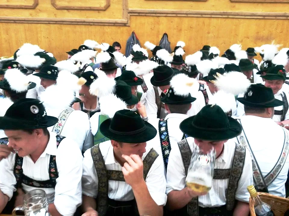 Men wear lederhosen . Women don the dirndl.