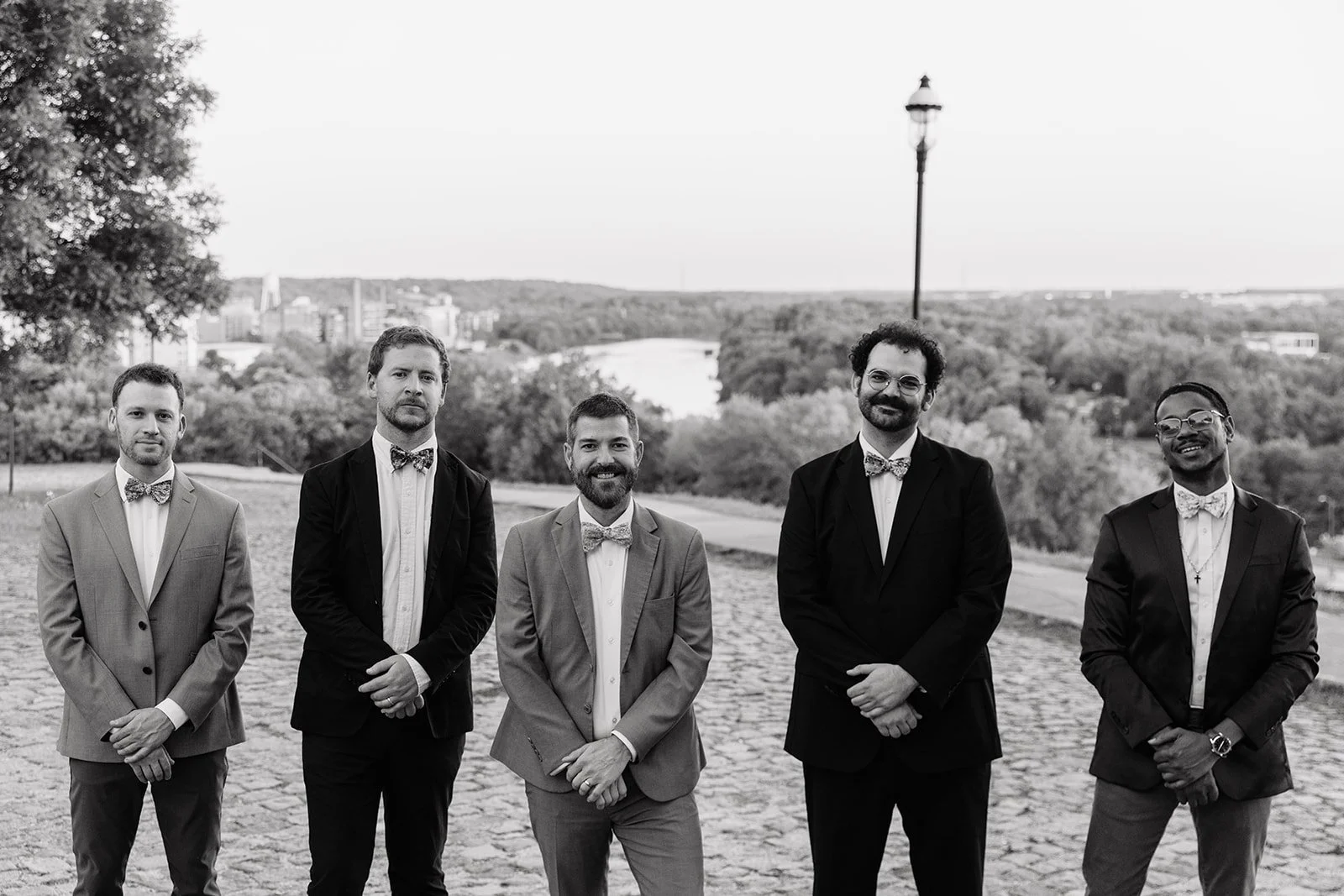 The Bow Tied Band stands overlooking the James River in a black-and-white portrait, showcasing a luxury DJ-led live band experience for weddings, galas, and corporate events in Richmond, Virginia.