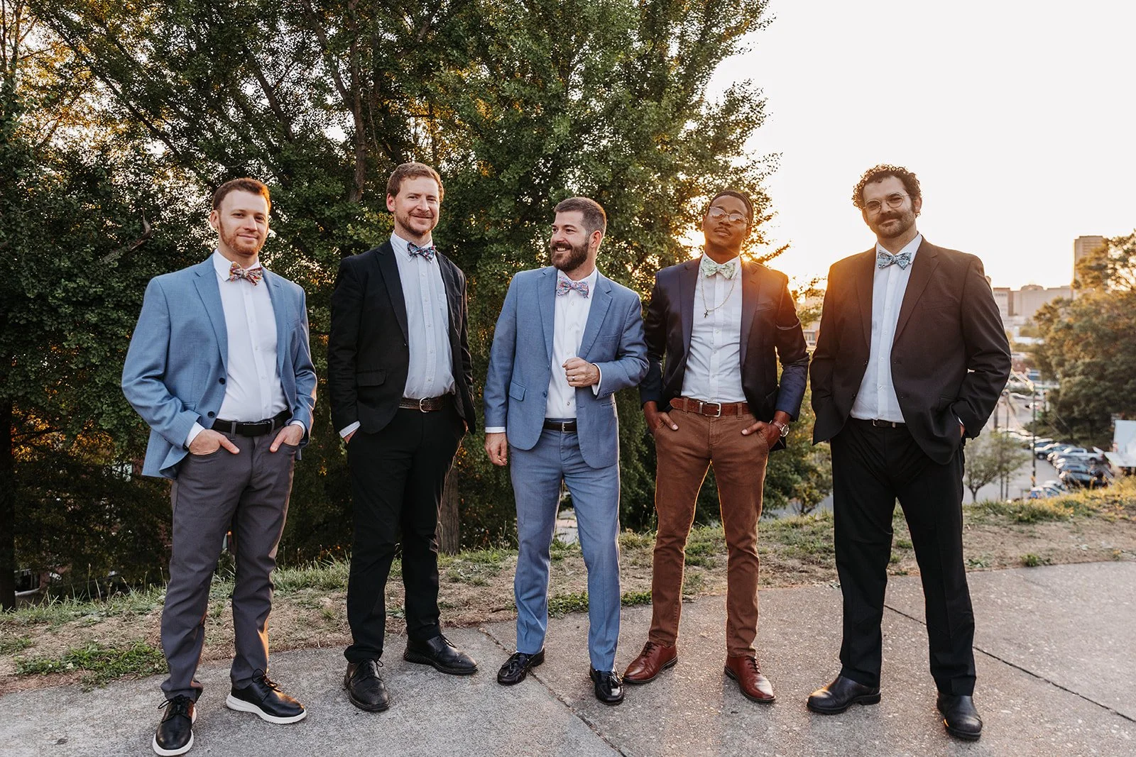 Members of The Bow Tied Band stand together outdoors at sunset, showcasing a DJ-led live music experience that combines a professional DJ and MC with talented musicians for luxury weddings, galas, and special events.