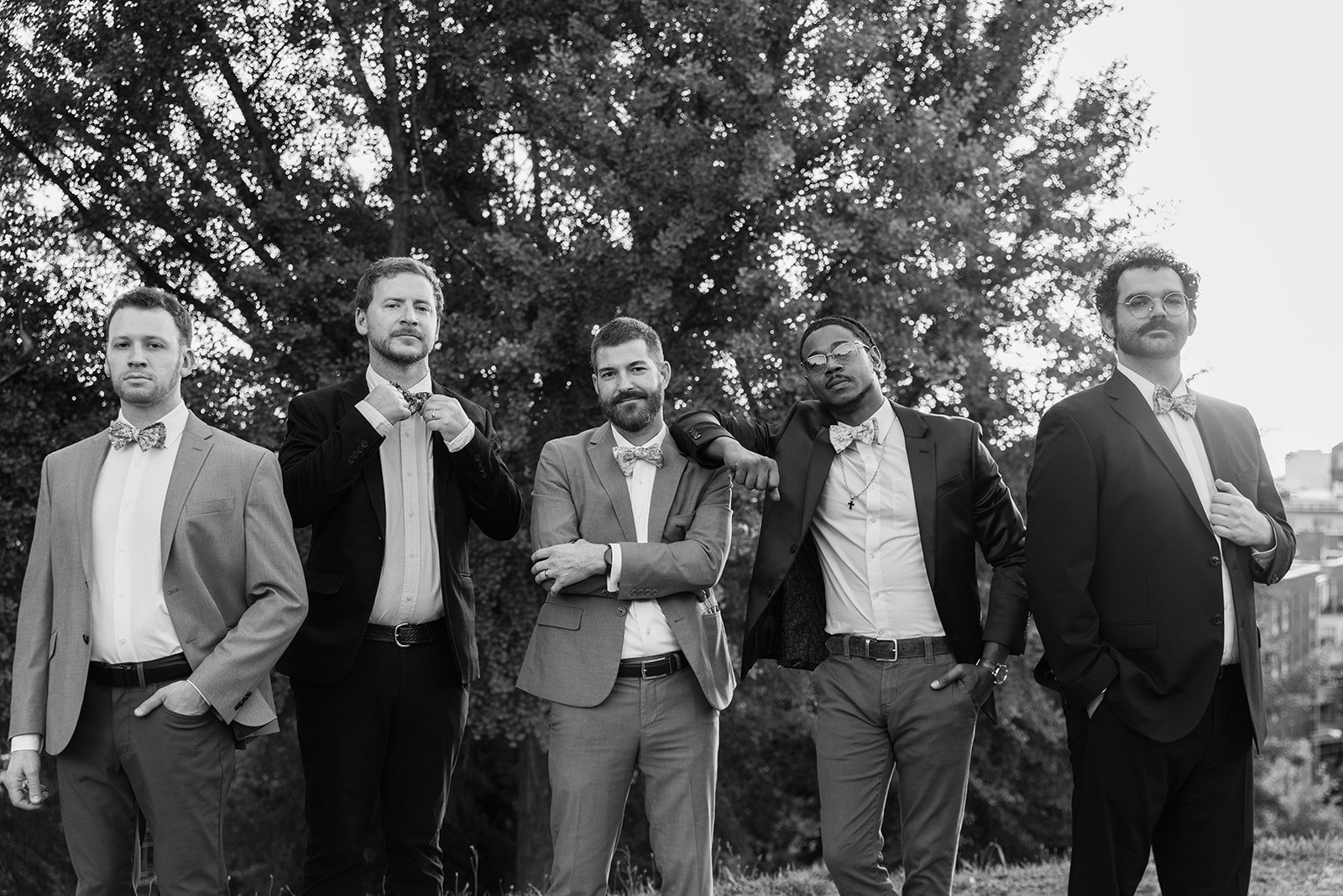 The Bow Tied Band members pose together in a black-and-white portrait, showcasing a stylish DJ-led live music ensemble for luxury weddings, galas, and upscale celebrations.