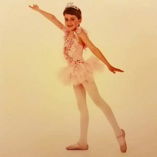 One of my first recital costumes, late 1980s. The photographer kept moving my limbs into place for me. This is me concealing the strain quite well.