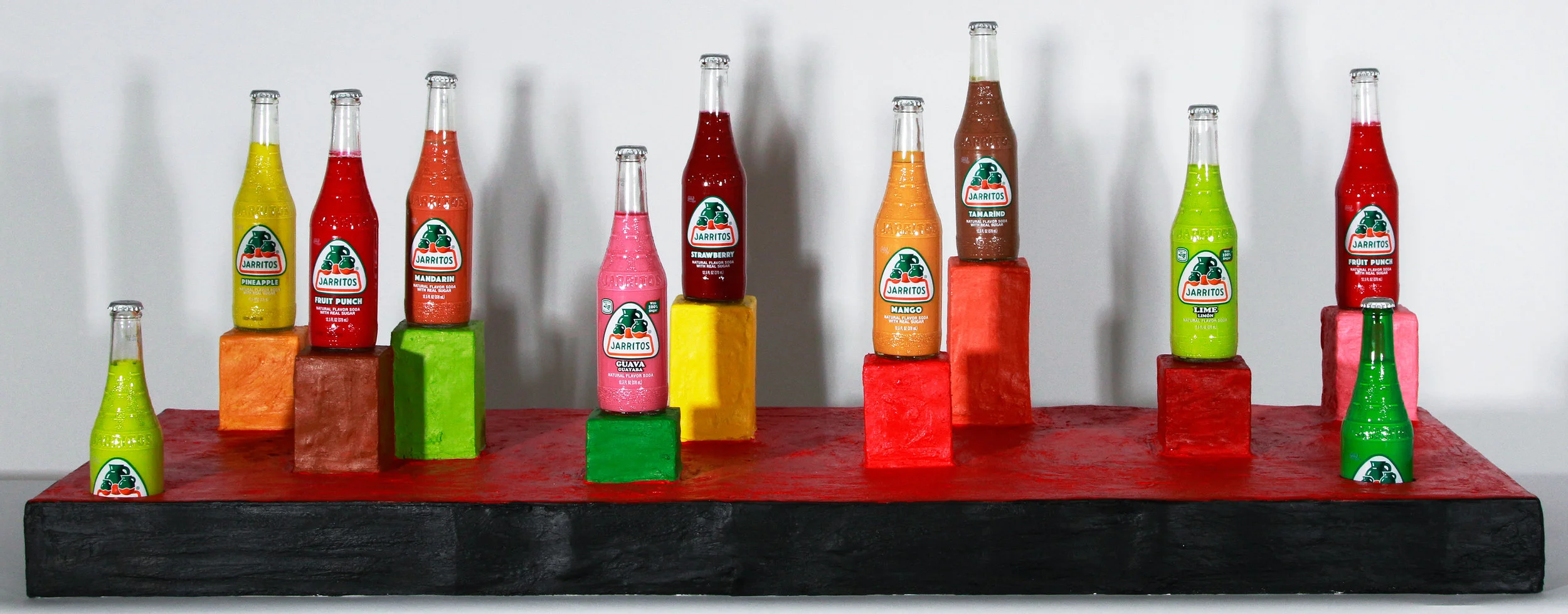 Ciudad de inmigrantes tempera in Jarritos glass bottles, acrylic on plaster on chipboard