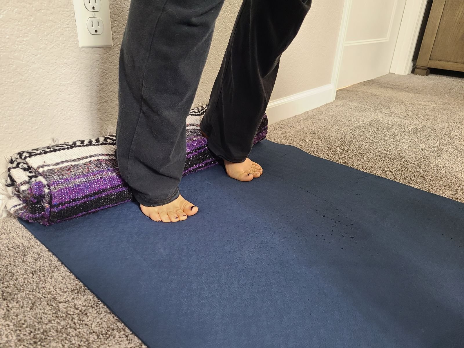 downward dog with rolled blanket under heels