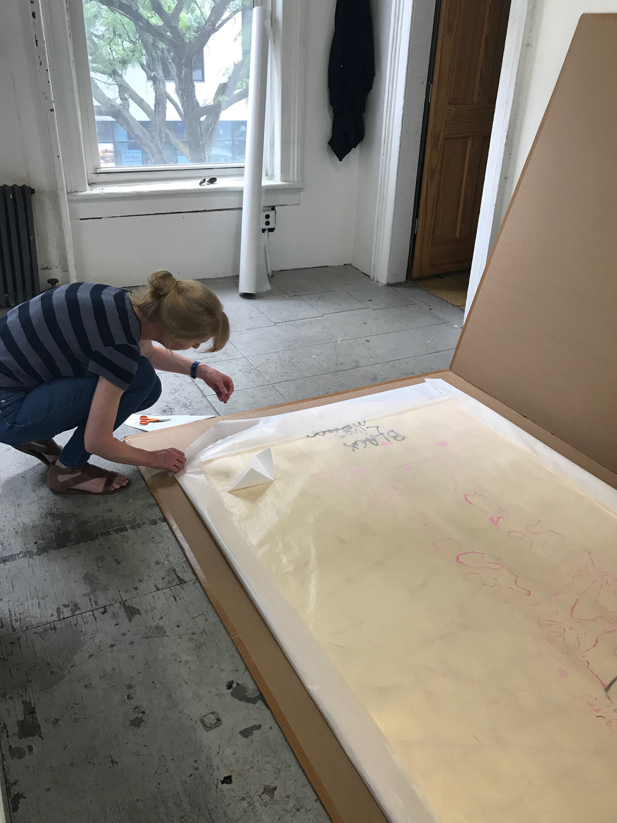 Elyse-Driscoll-Assistant-Paper-Conservator-Brooklyn-Museum-wrapping-WRWWABR-(for-MH)-to-be-moved-to-the-museum-after-acquisition.-My-QUEENSPACE-Residency-studio-Long-Island-City,-New-York-2018-taken-by-Stacy-Lynn-Waddell.jpg