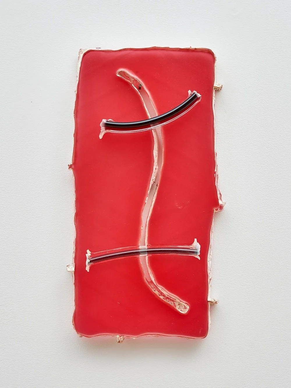   Yi Xin Tong,  Red Annulus , 2021, porcelain clay, resin, pigment, 7 x 5 x 1 inches. Photo credit: Kunning Huang.    