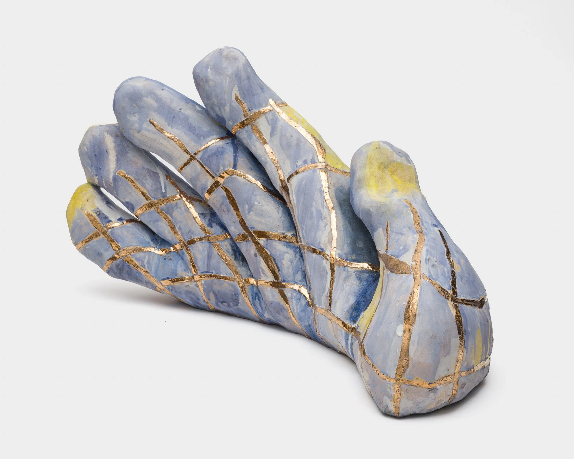 Julia Haft-Candell,  Hand with Weaving , 2023, Ceramic, gold, bronze, 18 x 33 x 10 inches.