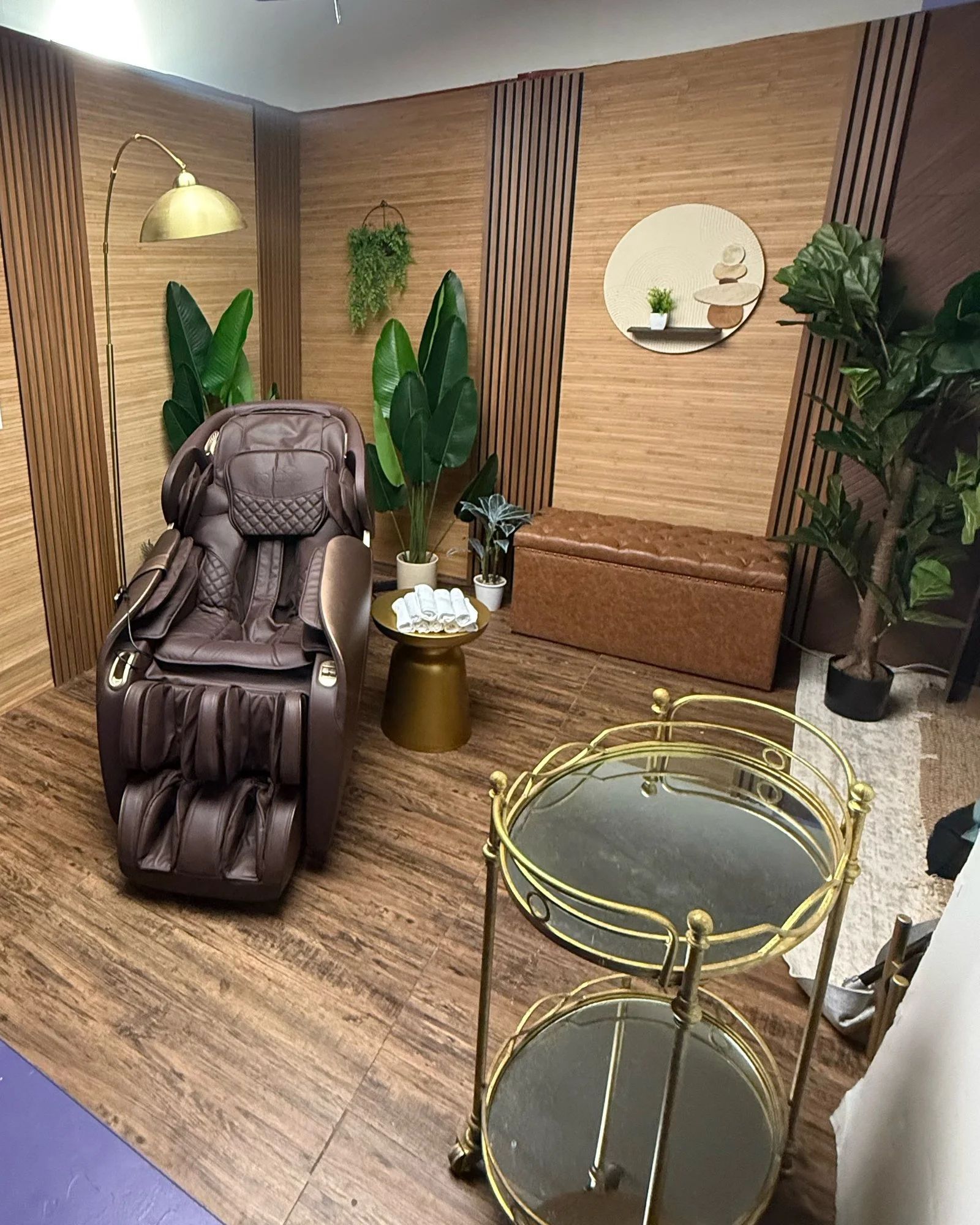 Asian spa set in the Back Studio at Ronin Creative Studios, Miami: massage chair, wood-slat walls, wave painting and plants