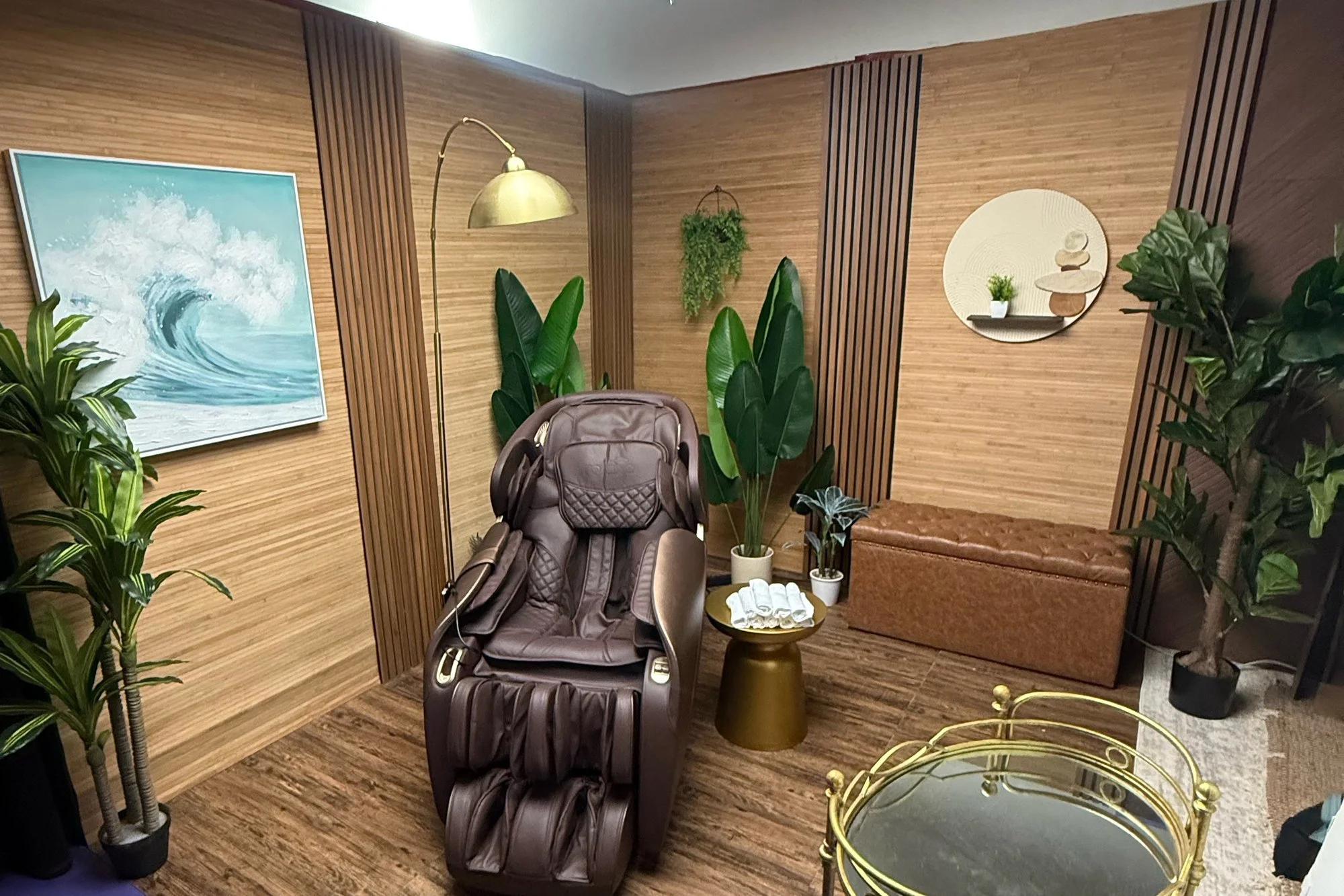 Asian spa set in the Back Studio at Ronin Creative Studios, Miami: massage chair, wood-slat walls, wave painting and plants