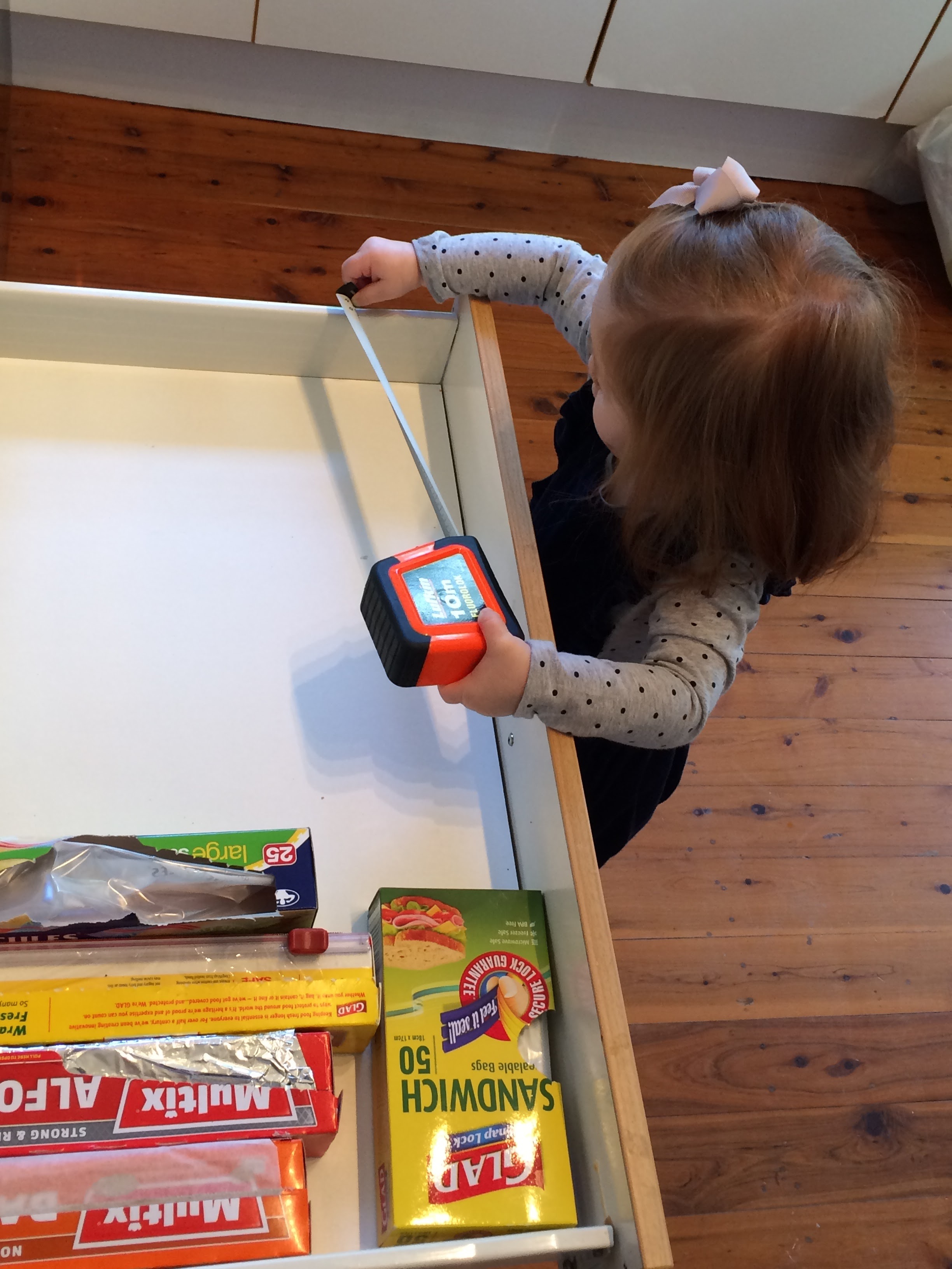 OUR LITTLE ONE MEASURING UP THAT KITCHEN - SHE IS READY TO GET THIS STARTED!!