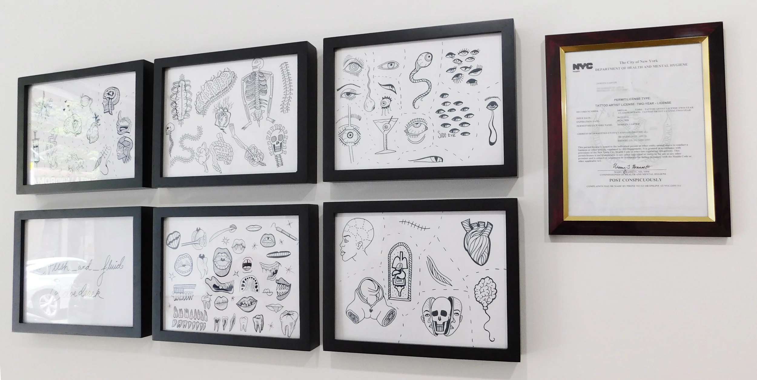 Doreen Garner's flash art for tattooing, and her tattoo artist license. Photo by the author. 