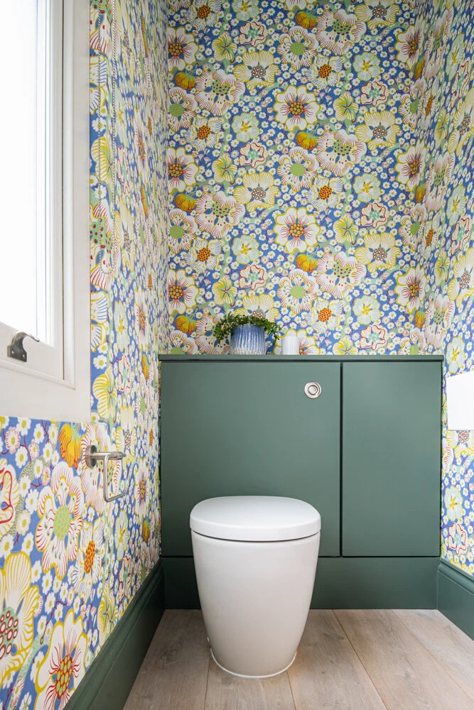 Bright Floral wallpaper to downstairs WC with white oak floor by Lendel Stephens Architects