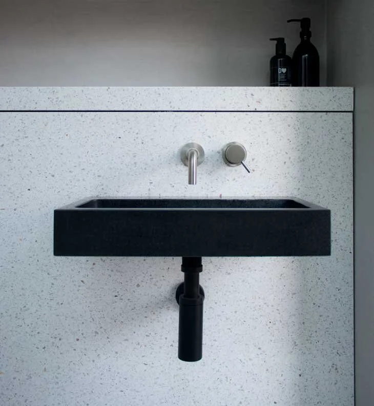 Terazzo and tadelakt plaster with polished black slate basin