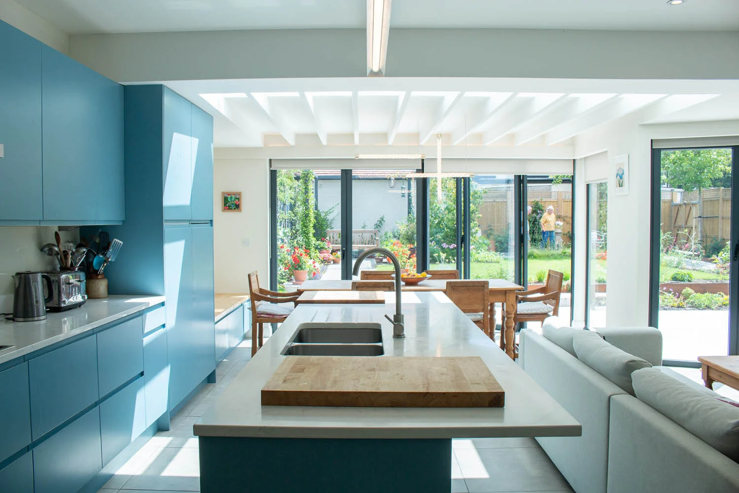 Simple bright kitchen interior looking out to garden by Lendel Stephens Architects
