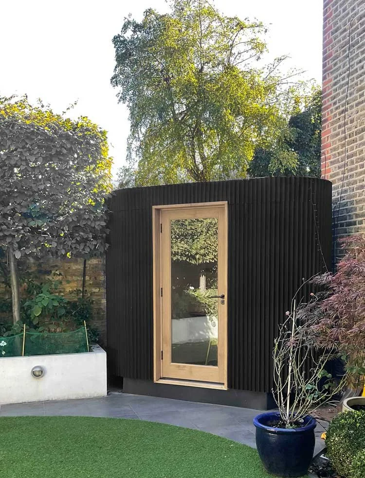 Workaday Plectrum garden office in corner of small garden