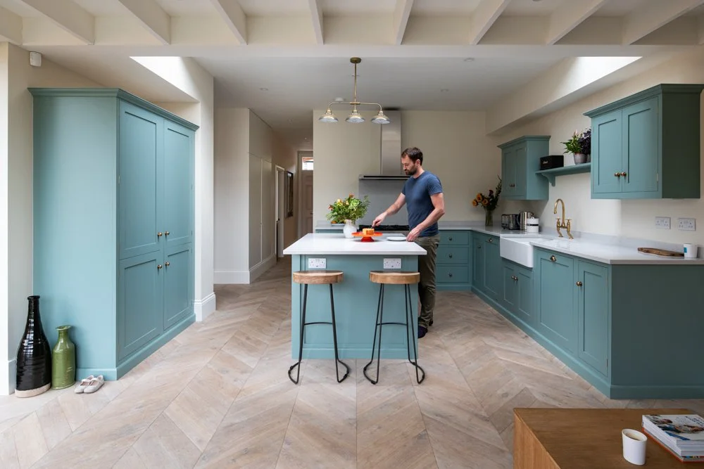 Kitchen in the rear extension at Lordship Lane, with painted ceiling beams, roof lights and shaker cabinetry.