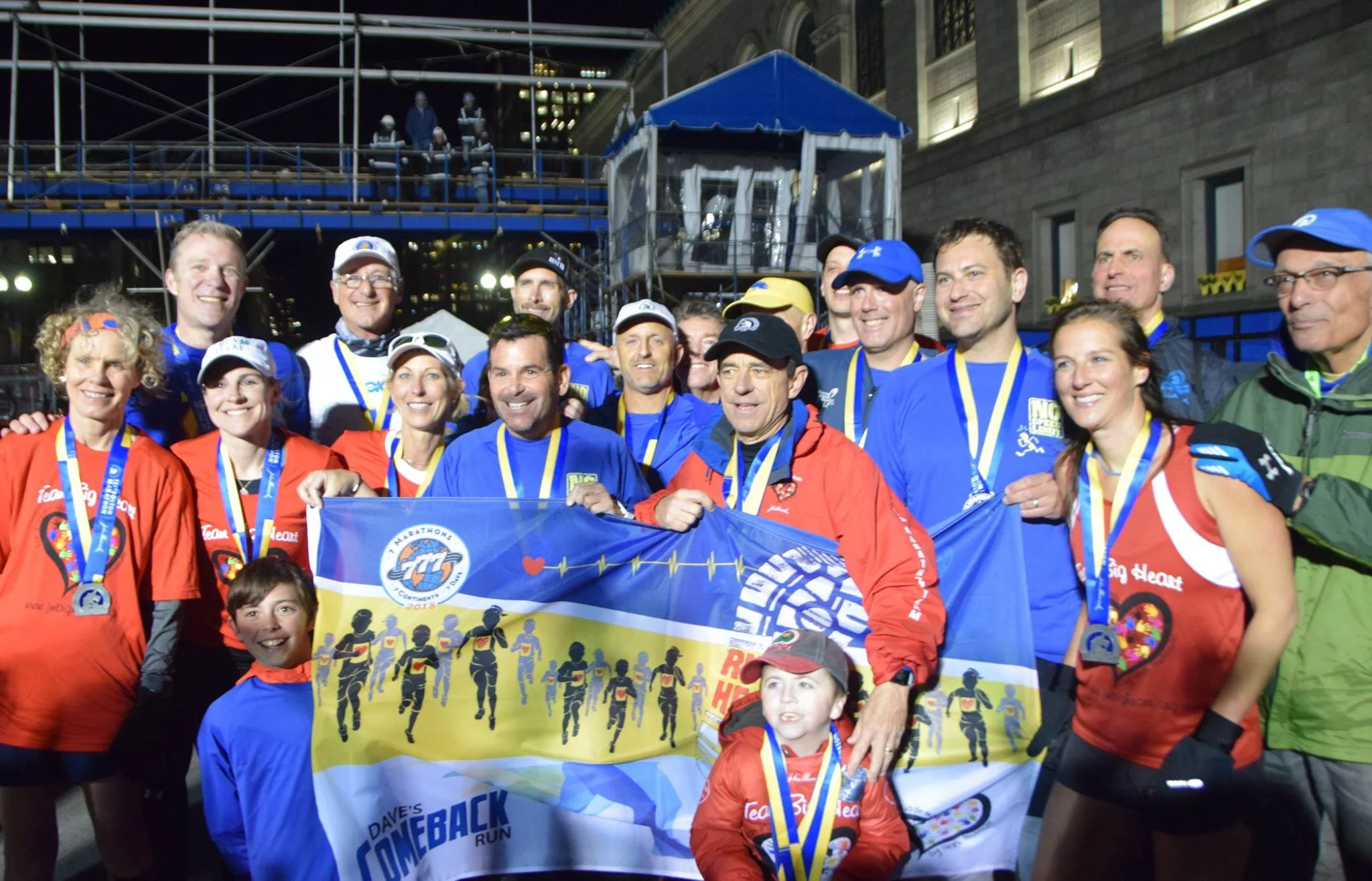 Dave McGillivray and his team of runners pose at the finish line for the completion of his “comeback run.” Bob McGillivray
