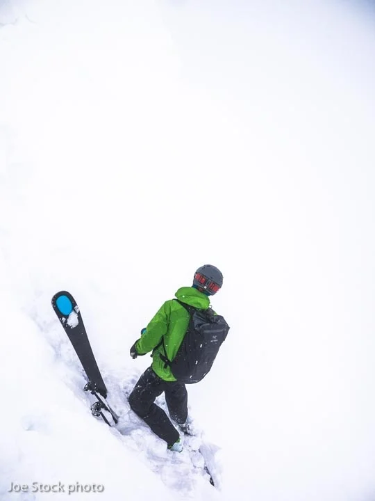 Mike Bromberg searches for the entrance. Revelstoke, British Columbia. 