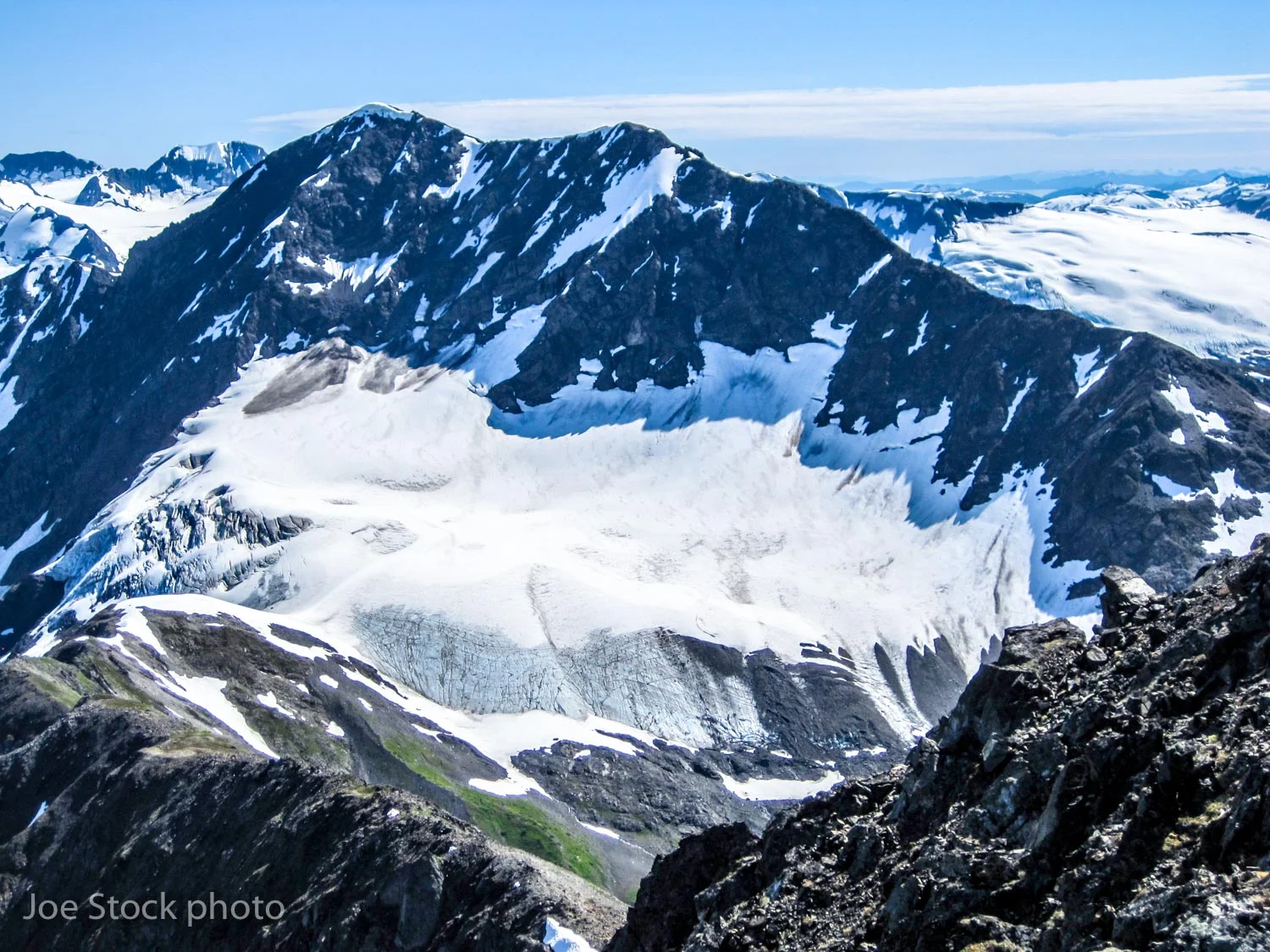 A small, unnamed glacier in the Chugach Mountains. This glacier's equilibrium line altitude is at a good position for a healthy glacier. The problem is, this photo was taken in early July. Two months of summer melt season remain. Many small glaciers in Alaska will soon be gone.