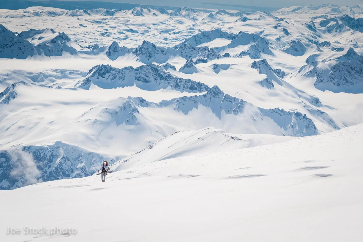 Dylan skinning toward the summit of Mount Spurr. Neacola Mountains beyond. 