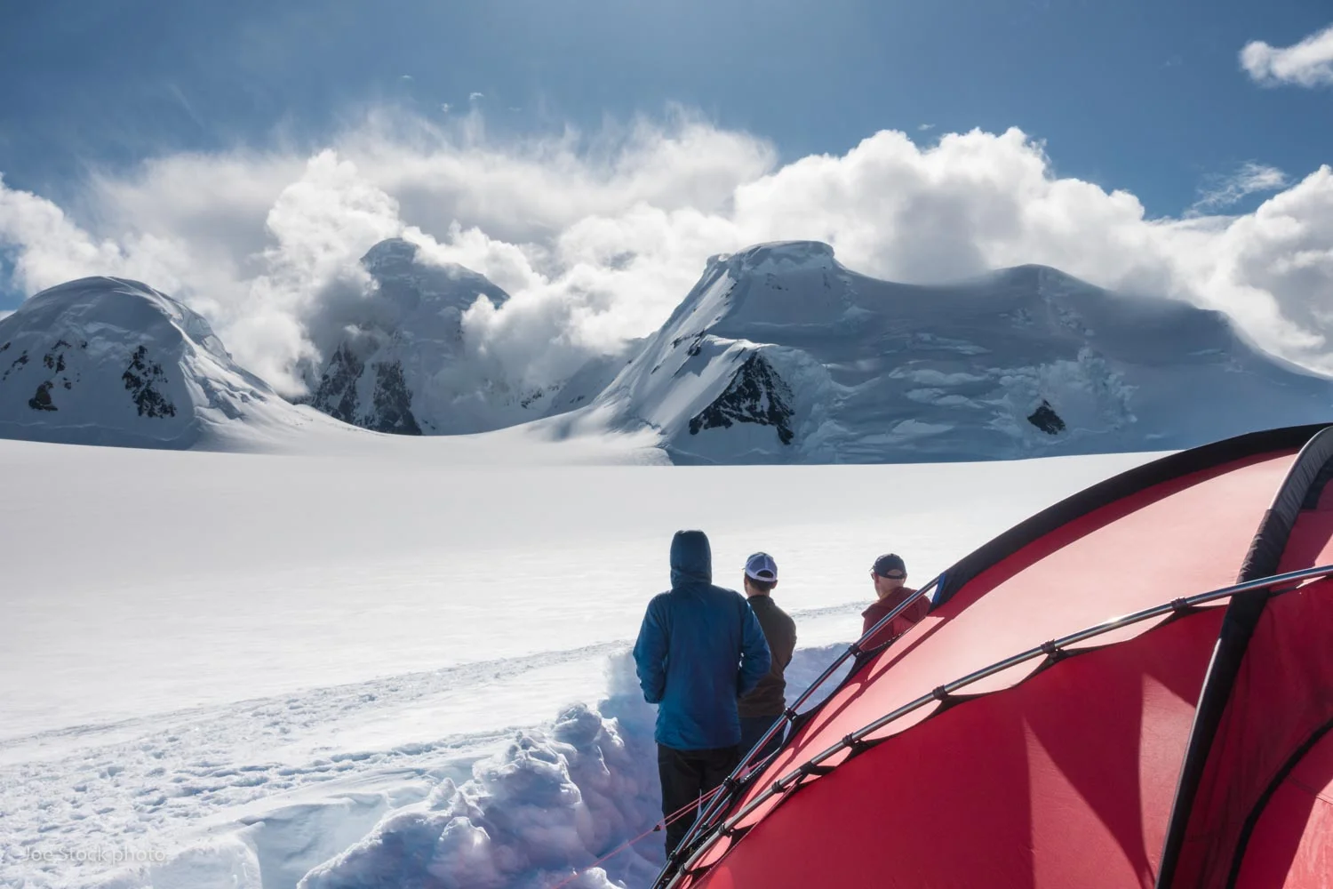Our camp was perched on a 7,500-foot bench of the Yentna Glacier, surrounded by peaks including the mighty Mount Russell (11,670 feet) at the head of the valley. Denali ranger Tucker Chenoweth calls this location Island in the Skye. His daughter is named Skye. It did feel like an island. There’s no easy escape from this island enclosed by rock walls and icefalls. We chose this place with the help of Steve Gruhn in Anchorage. Steve’s our man for adventure. Our plan A idea came from Steve, as well as our plan B. Weather during the trip was mostly light winds and clear skies. Good weather in this region typically comes with north wind, which flows hundreds of miles across the tundra, then hits the mountains where we camped. The air rises and condenses on the summits around us. It’s a rare day without clouds lurking on Mount Russell. Pilot Paul Roderick warned us about the weather in the area. Paul knows.