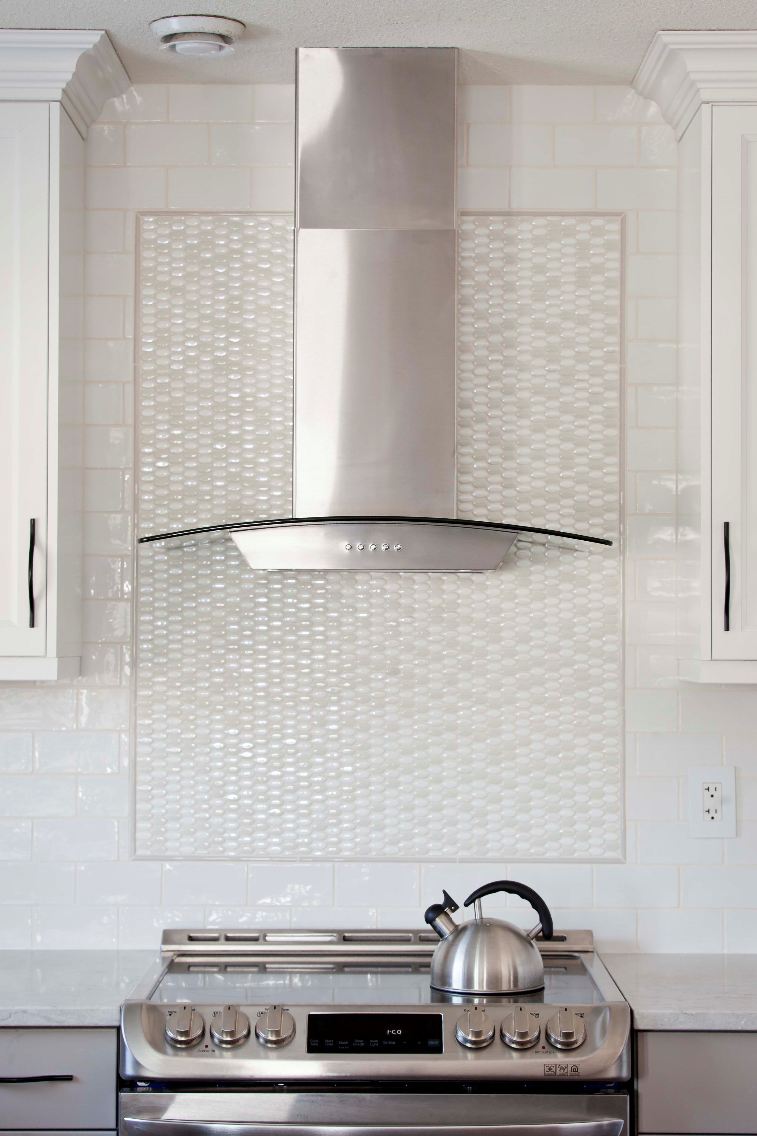 With feature tile work, the cooking area becomes a focal point in the kitchen.