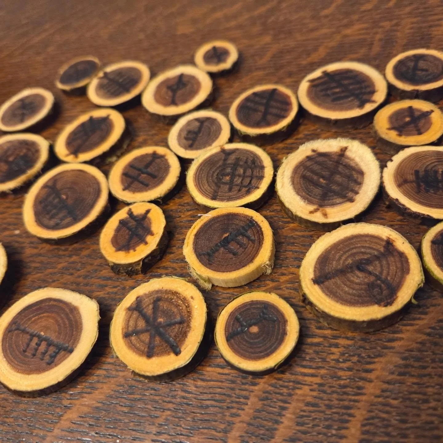 Seeking opinions! Okay so I tried making an Ogham set to sell. At first they came out nice, then I oiled the wood andddd they got super dark and you can barely read some of these medallions. Opinions - do these look too dark? Is this attempt a total 