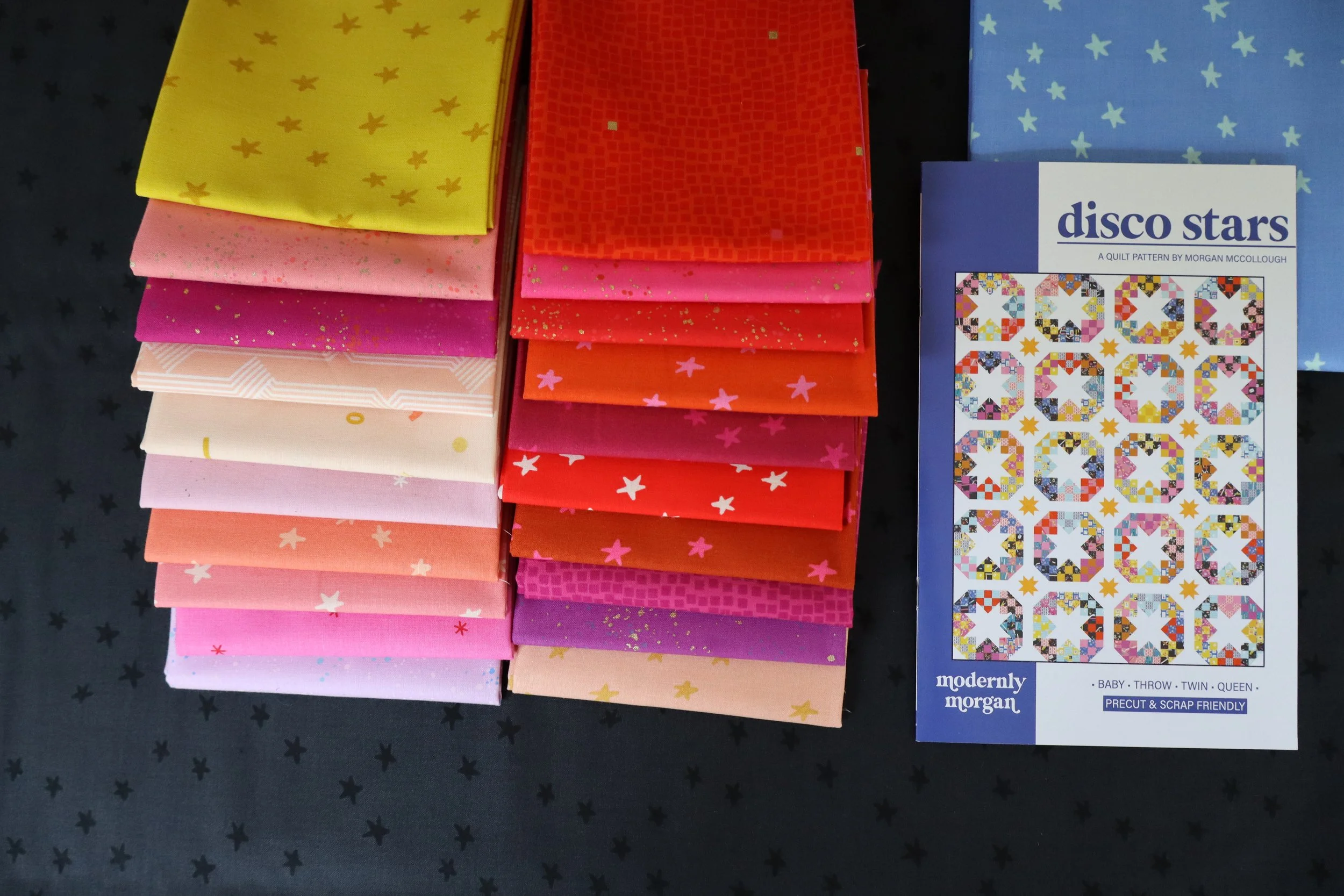 Disco Stars Fever quilt kit featuring Ruby Star Society fabrics in red, pink, and yellow — modern quilt pattern by Modernly Morgan.