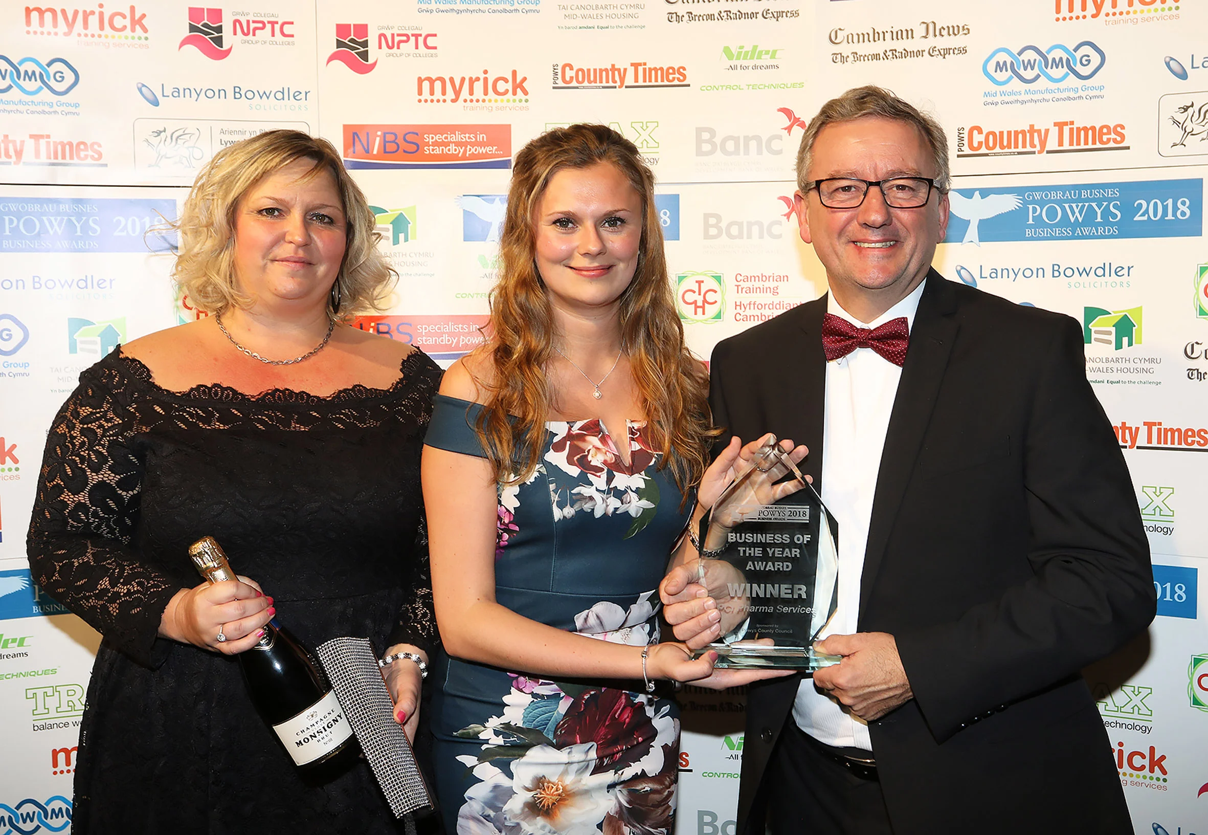 PCI Pharma Services’ training supervisor Tracey Lewis and account manager Paige Morgan receive the Powys Business of the Year Award from David Powell, of Powys County Council, sponsor.