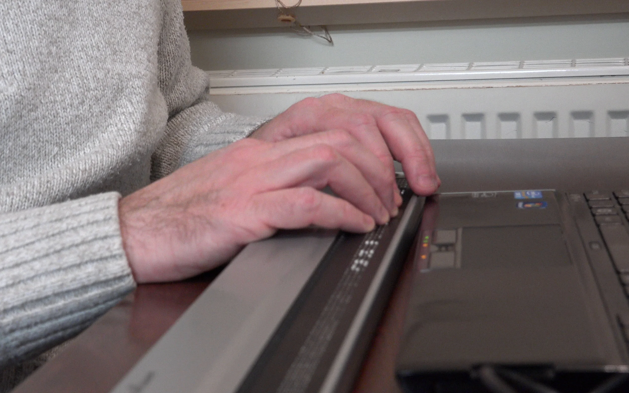 A blind musician reading music from a Braille terminal.
