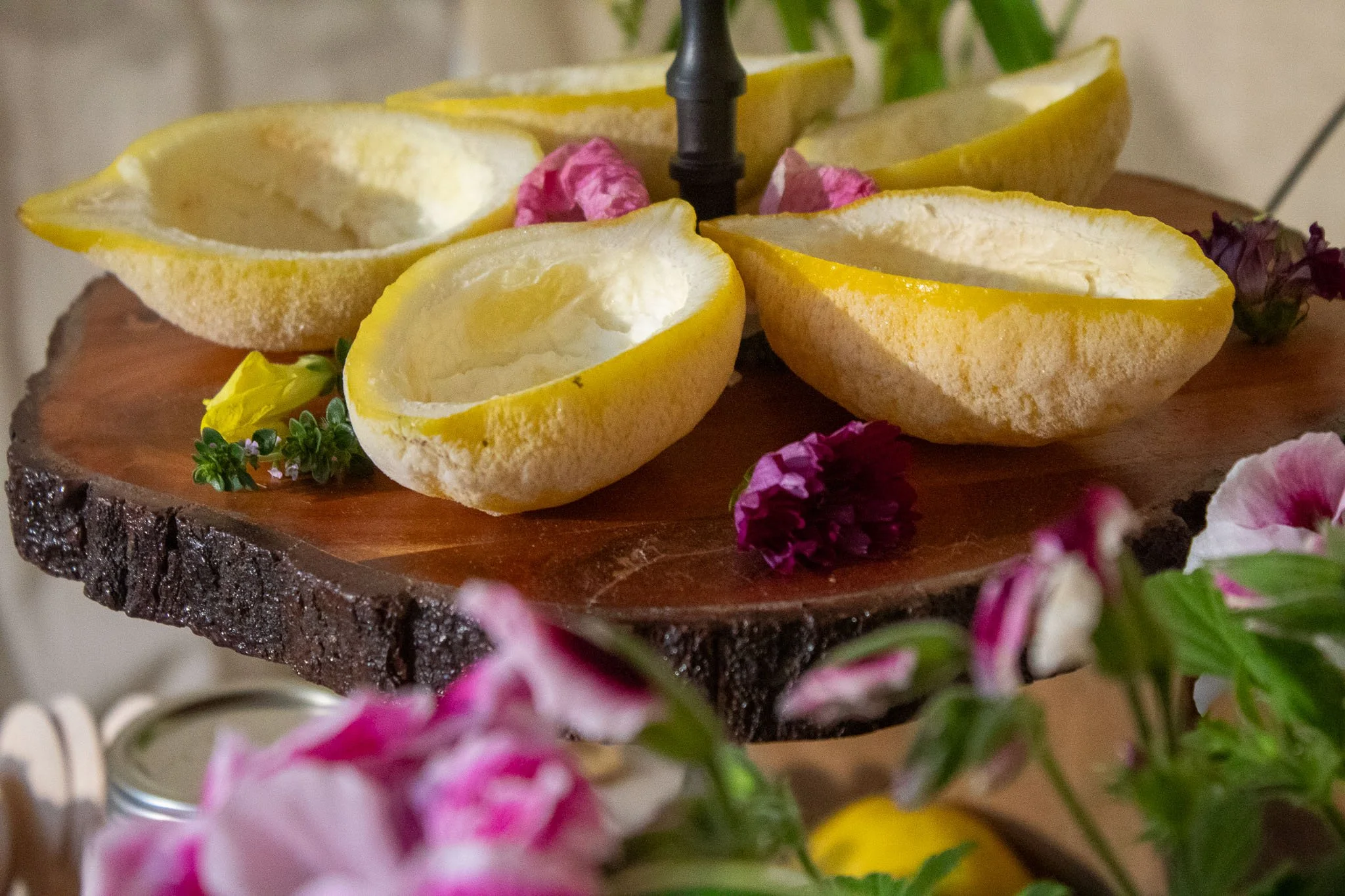 Hollowed lemon halves prepared as natural serving bowls for shaved ice at a lemon garden birthday party.