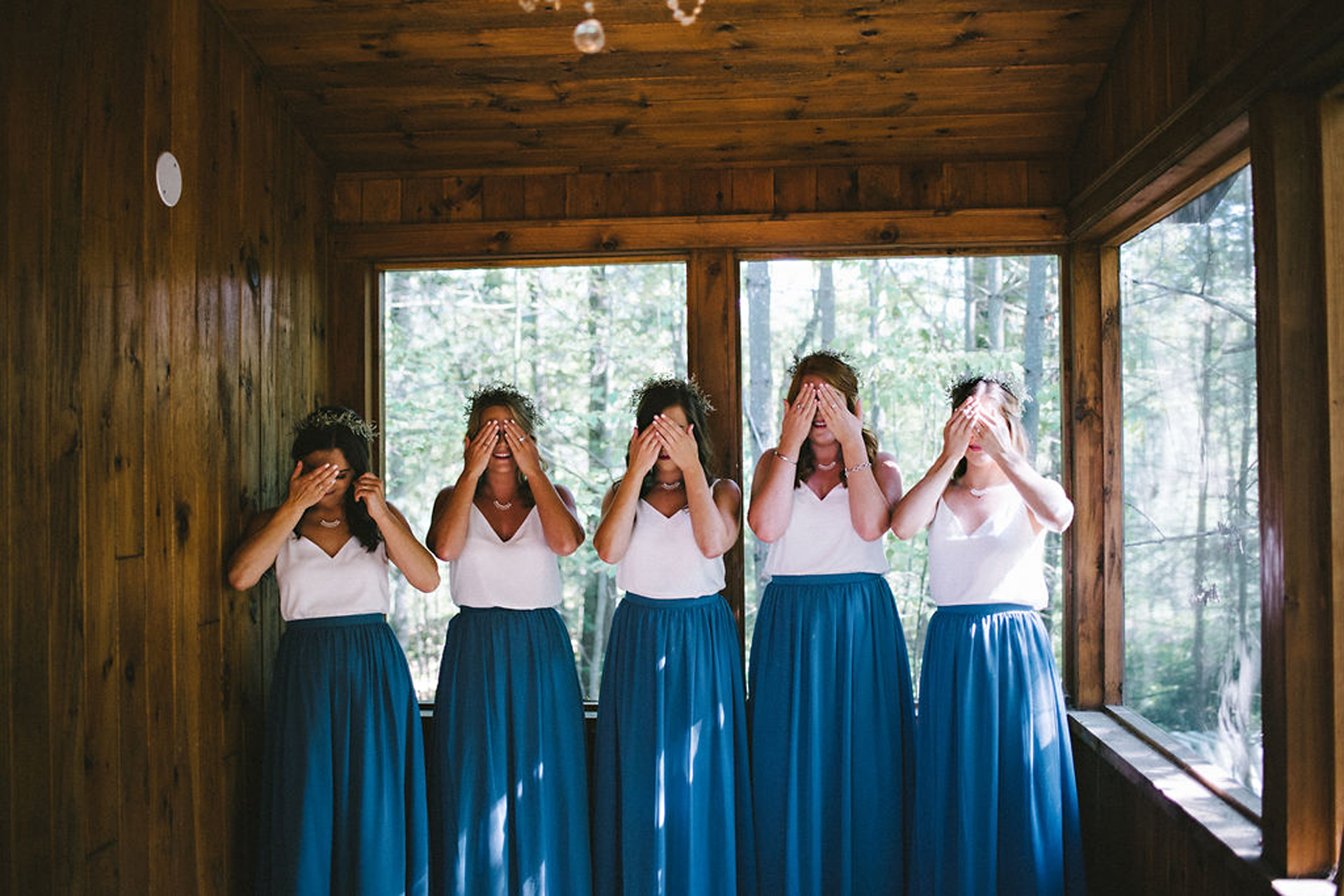 Bridesmaids wearing blue skirts and white camisoles
