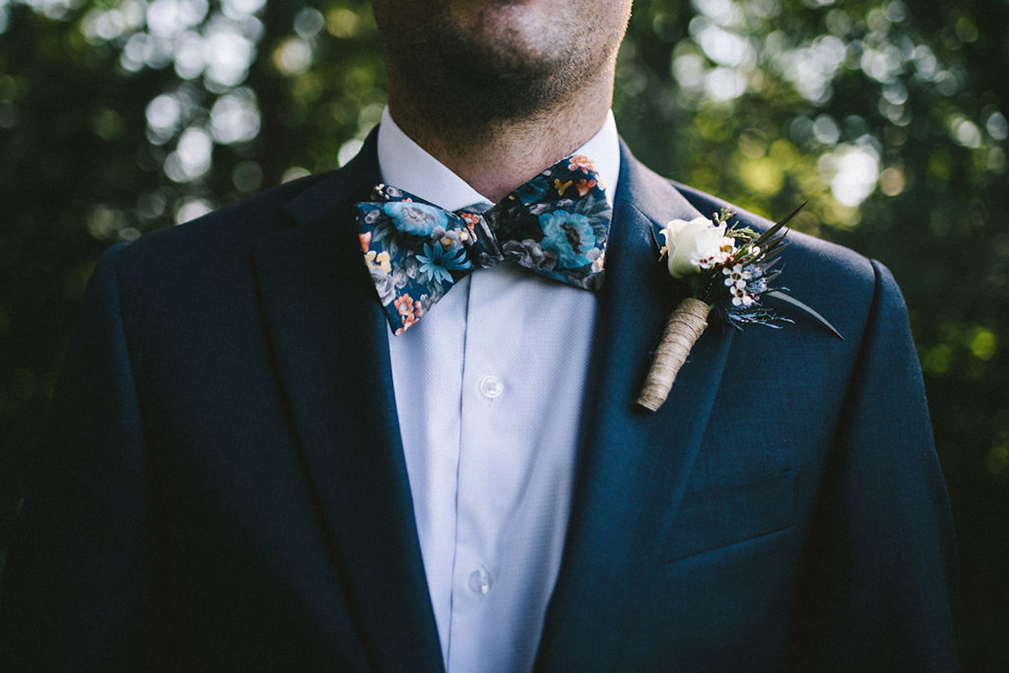 Floral bowtie groom style at camp wedding in Parry Sound
