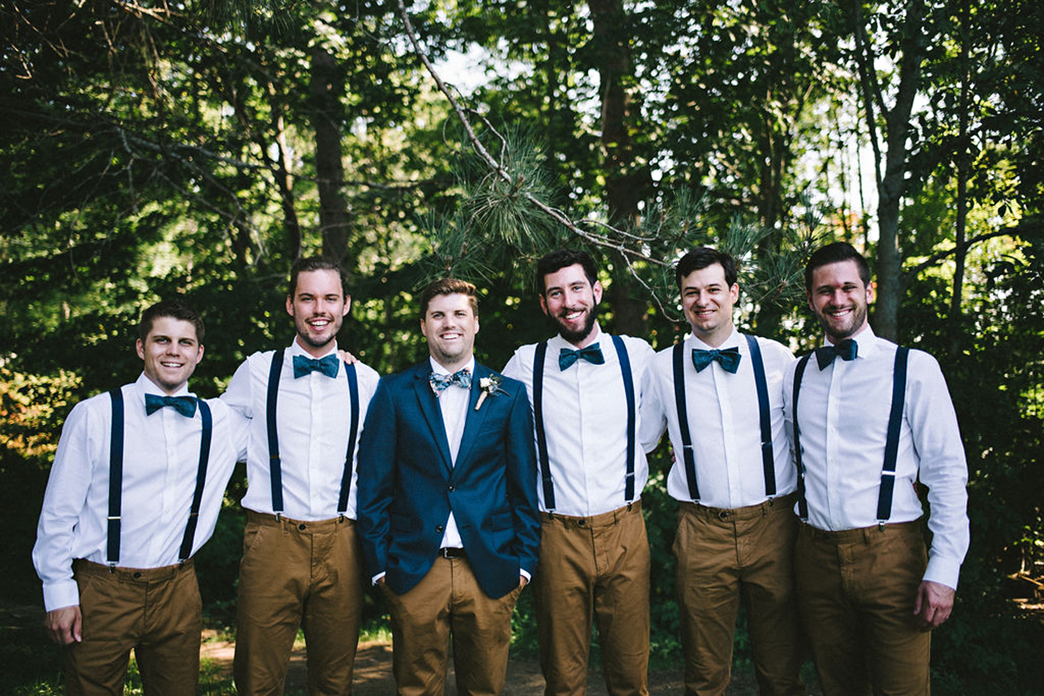 Groomsmen style in bowties and suspenders at Parry Sound camp we