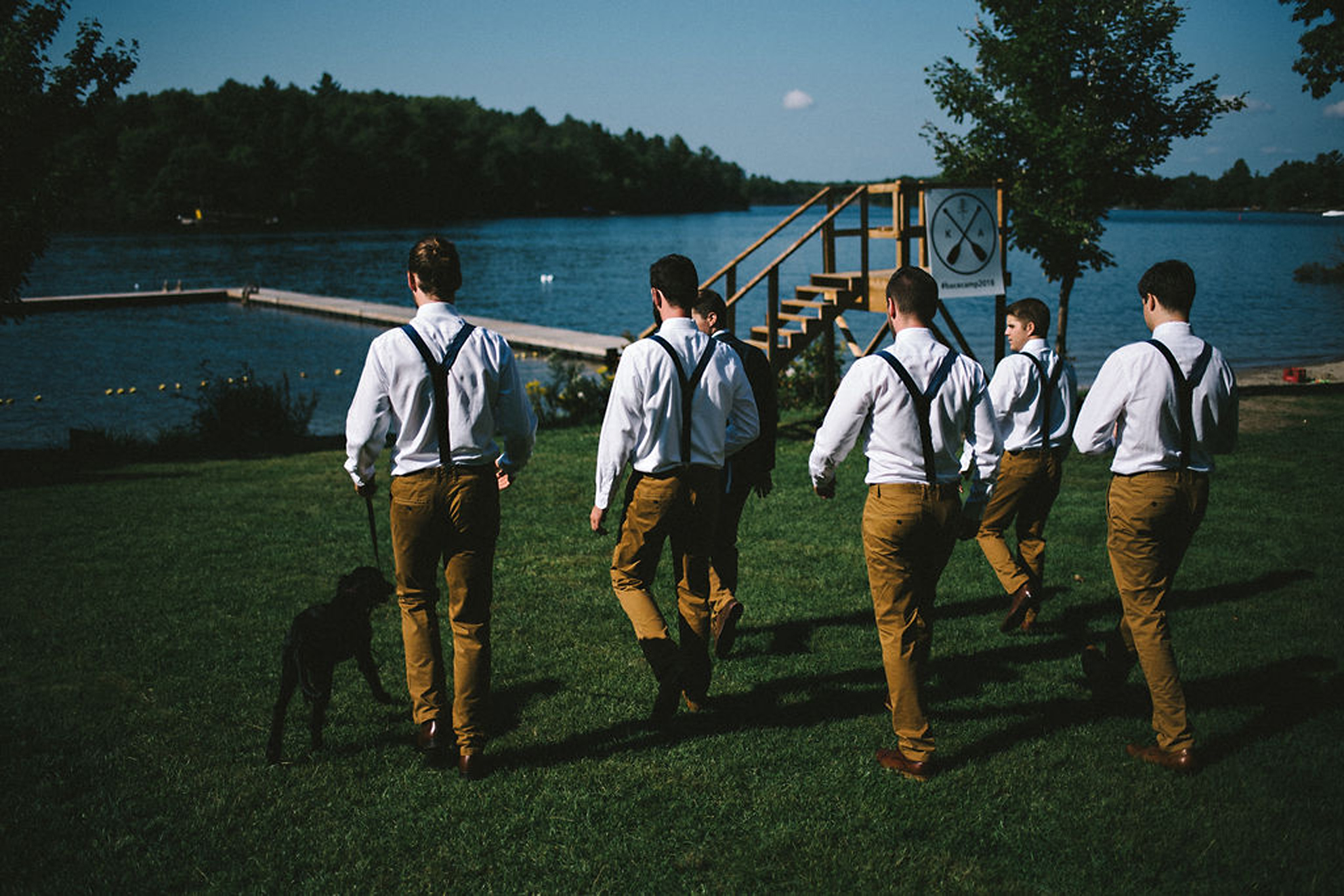 Groomsmen walking to dock at Parry Sound camp wedding