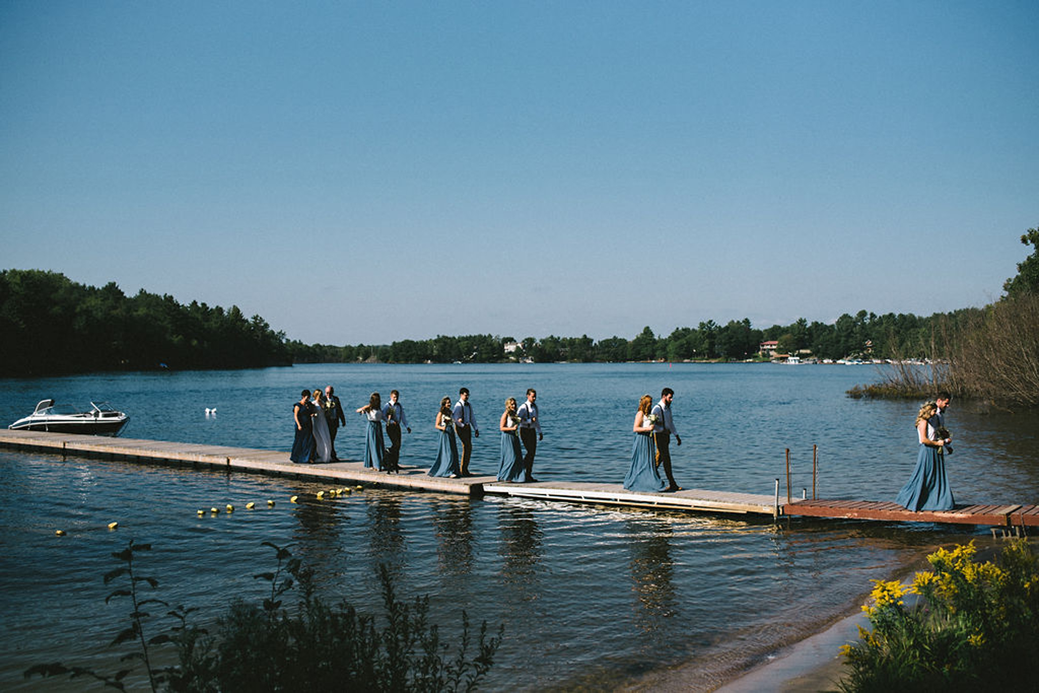 Wedding party arriving by boat at Parry Sound camp wedding