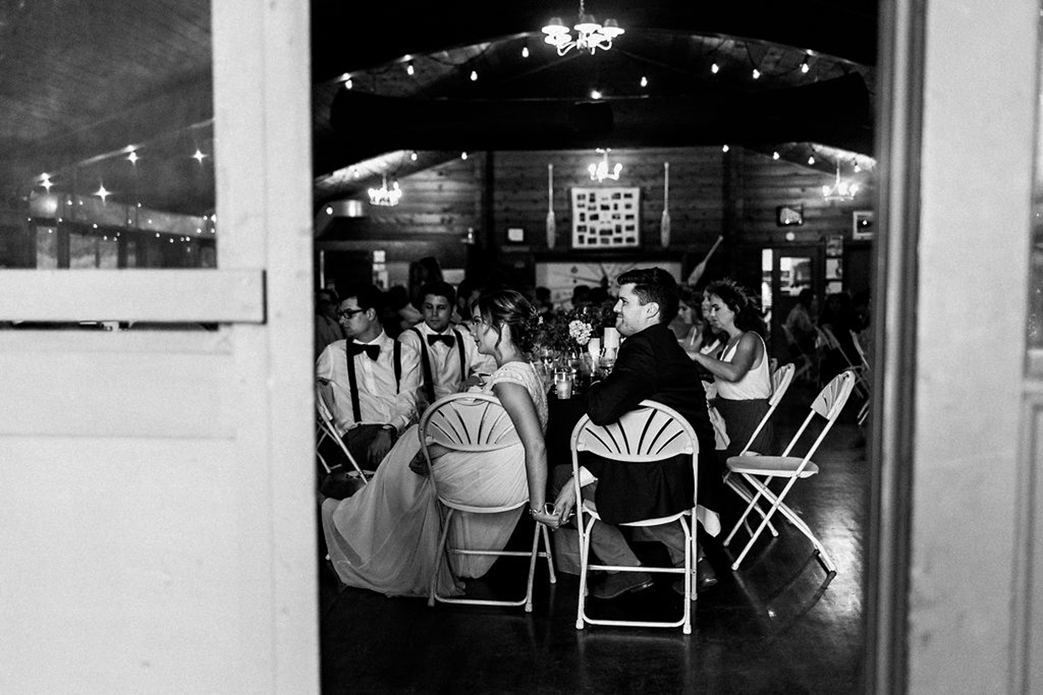 Couple holding hands during speeches at Parry Sound camp wedding