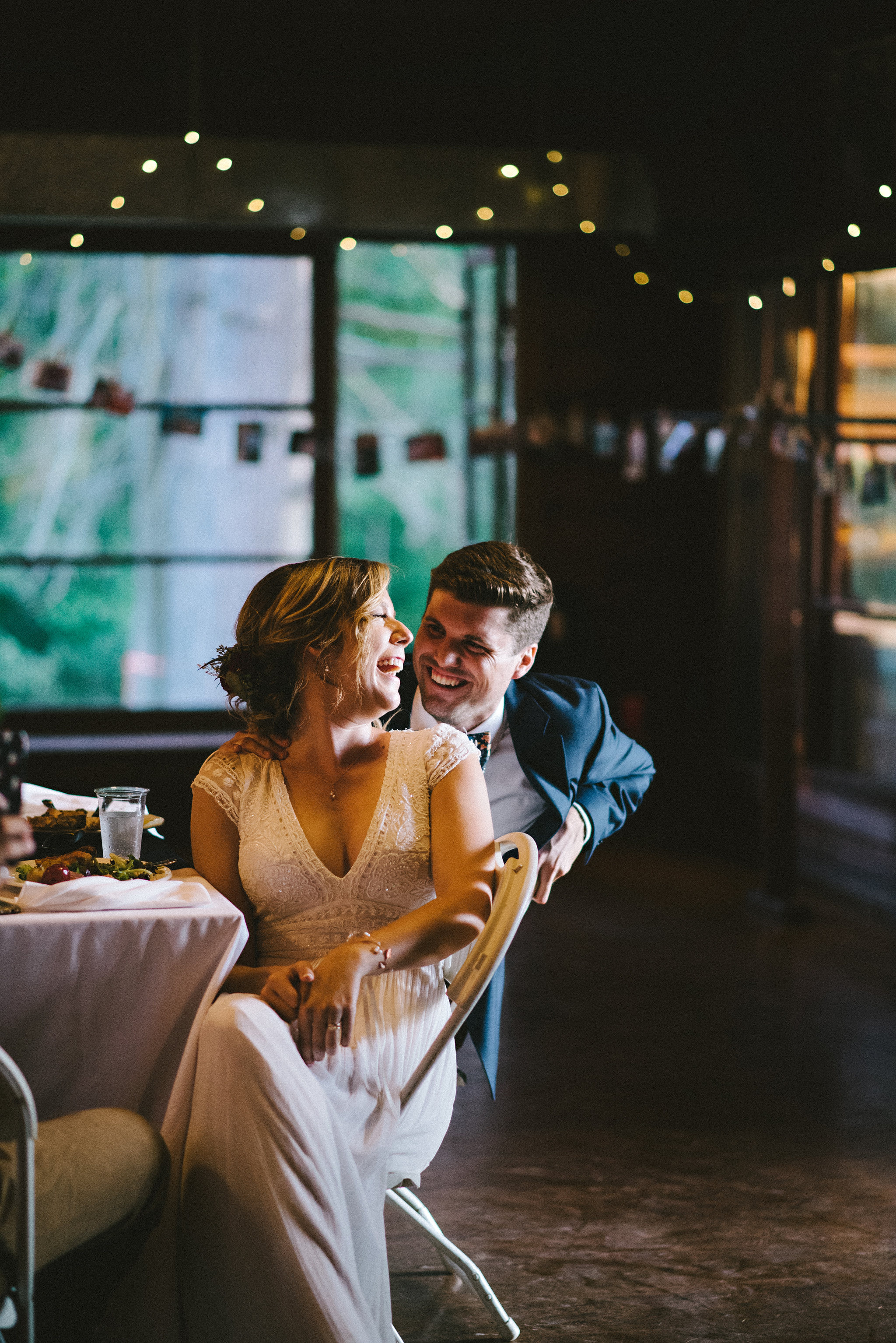 Couple laughing during speeches at Parry Sound camp wedding