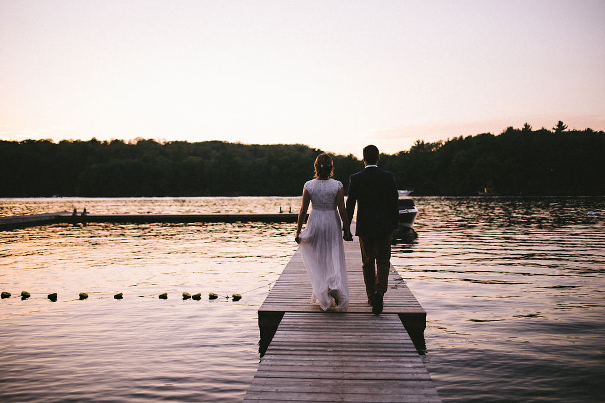 Bride and Groom walking on dock at Parry Sound camp wedding