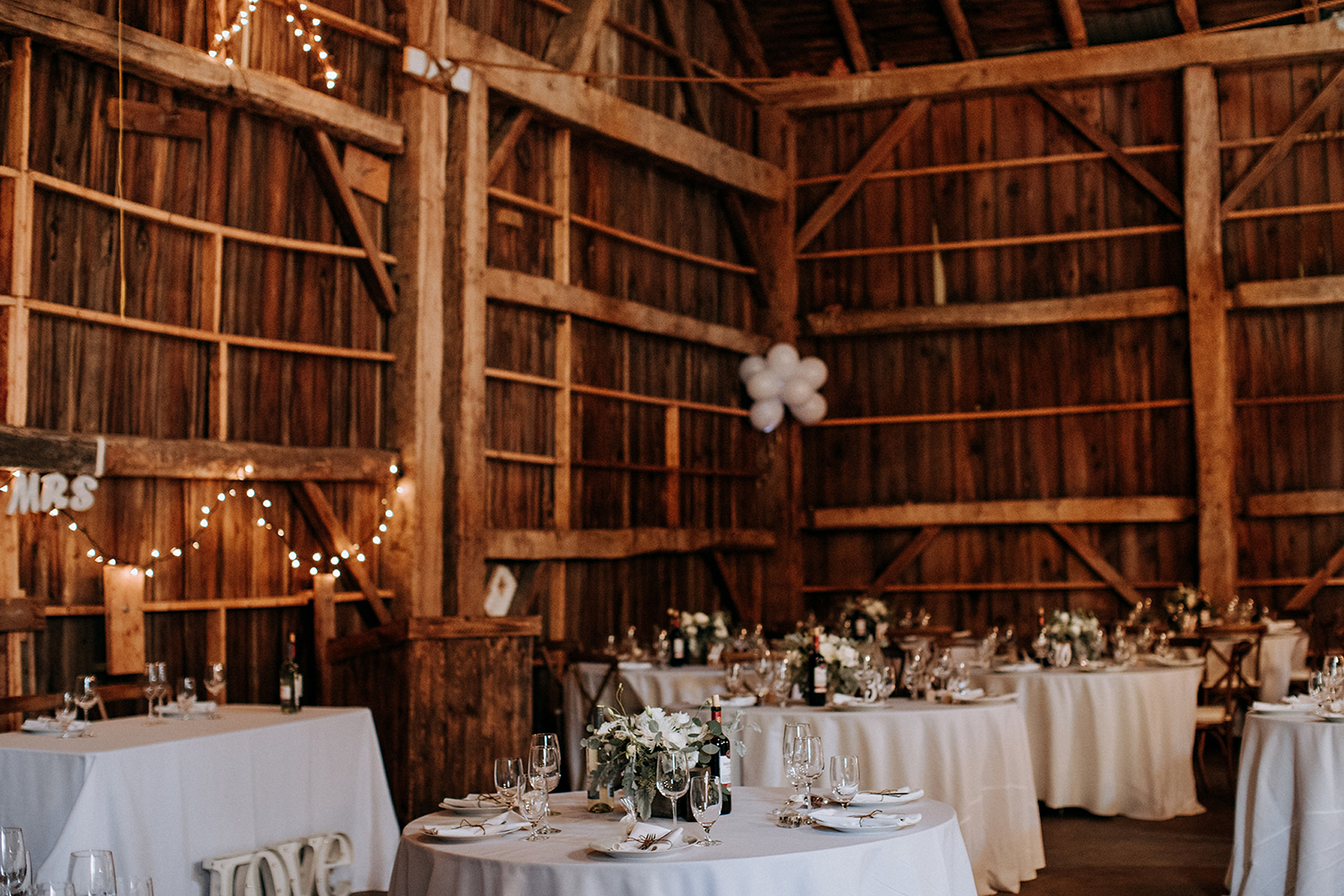 table settings with blush and white centrepieces at meaford barn