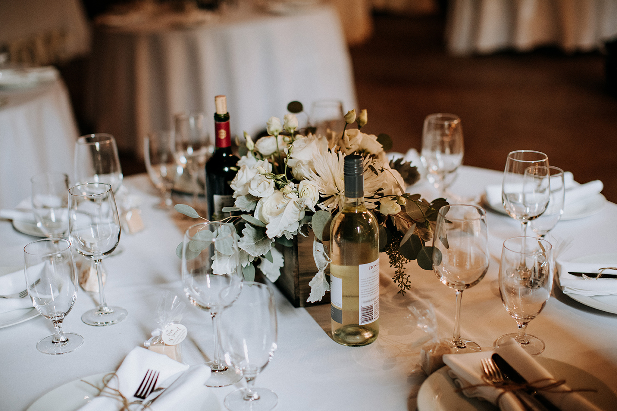 table settings with blush and white centrepieces at meaford barn