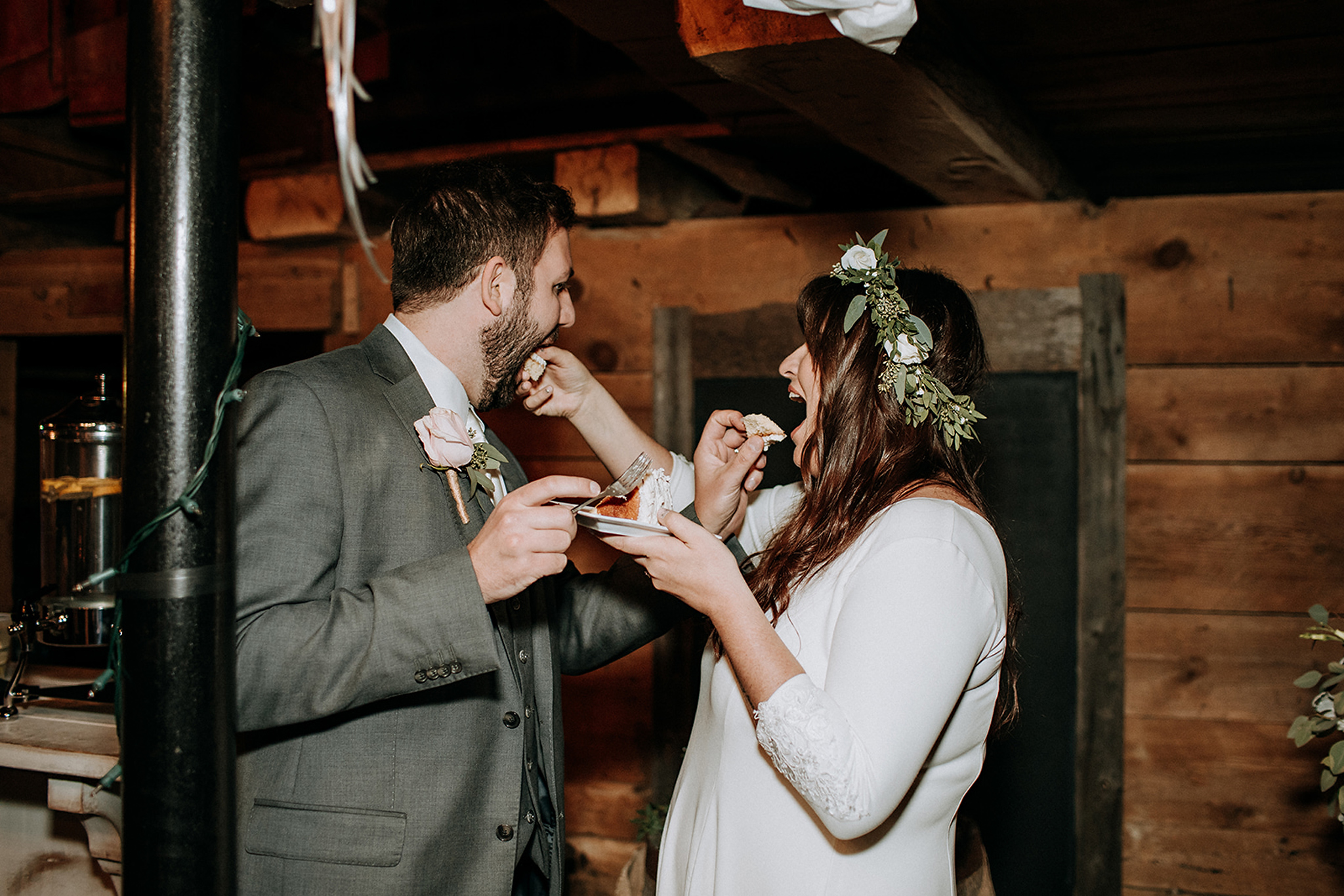 couple feeding each other cake at meaford barn wedding