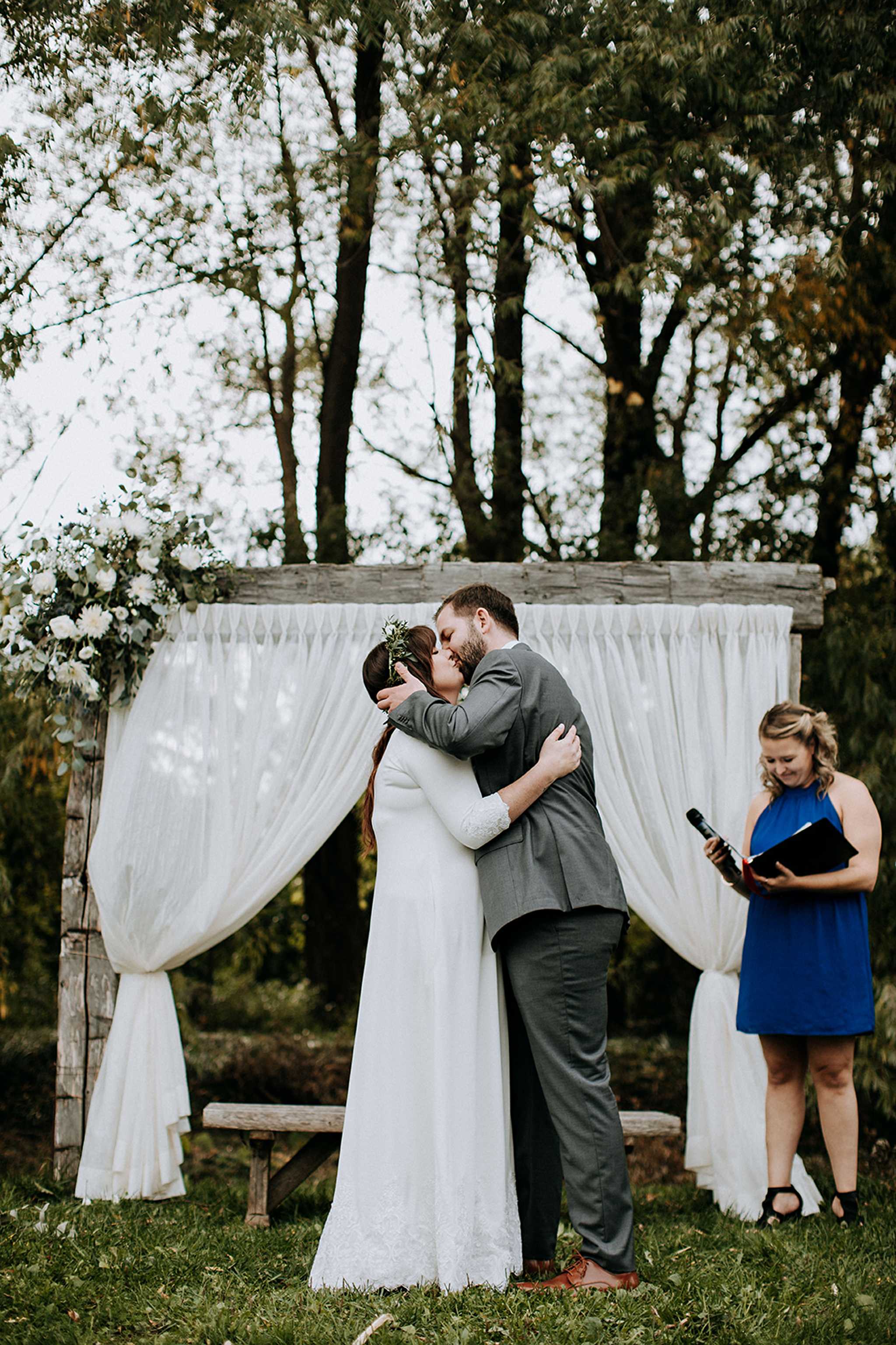 romantic first kiss under barn beam arch at meaford barn wedding