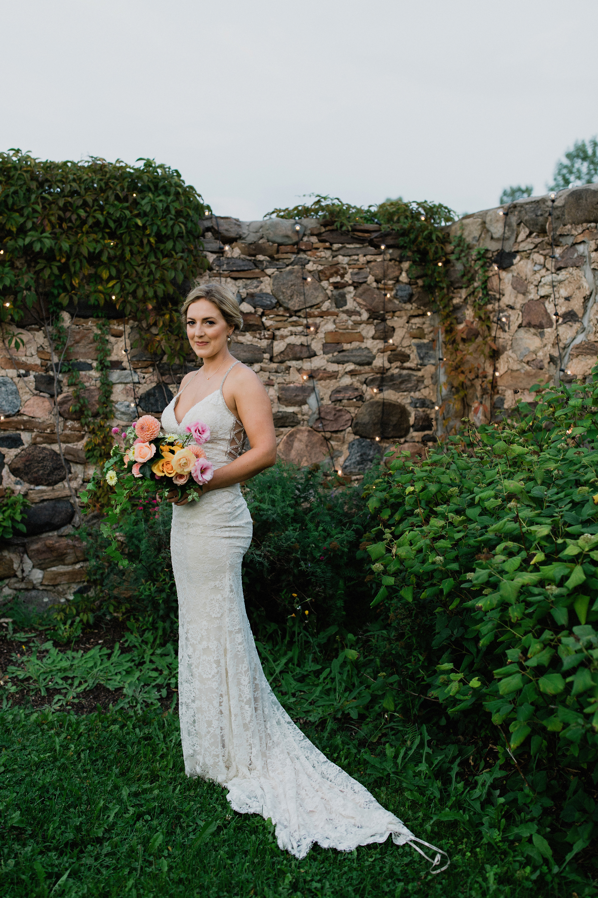 Romantic bride portrait with coral toned bouquet at Coffin Ridge