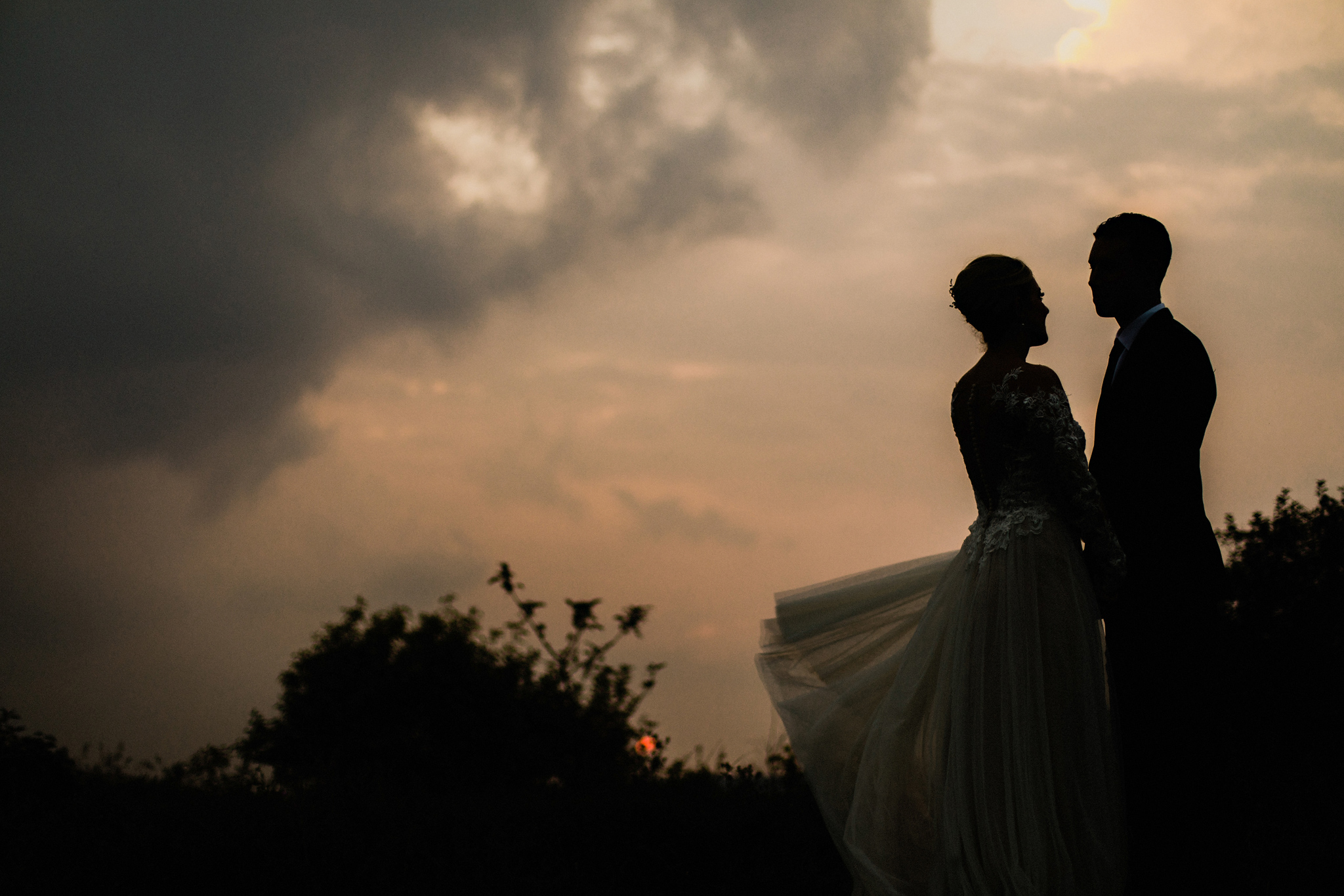 Bride and groom watching the dramatic sunset at Coffin Ridge Bou