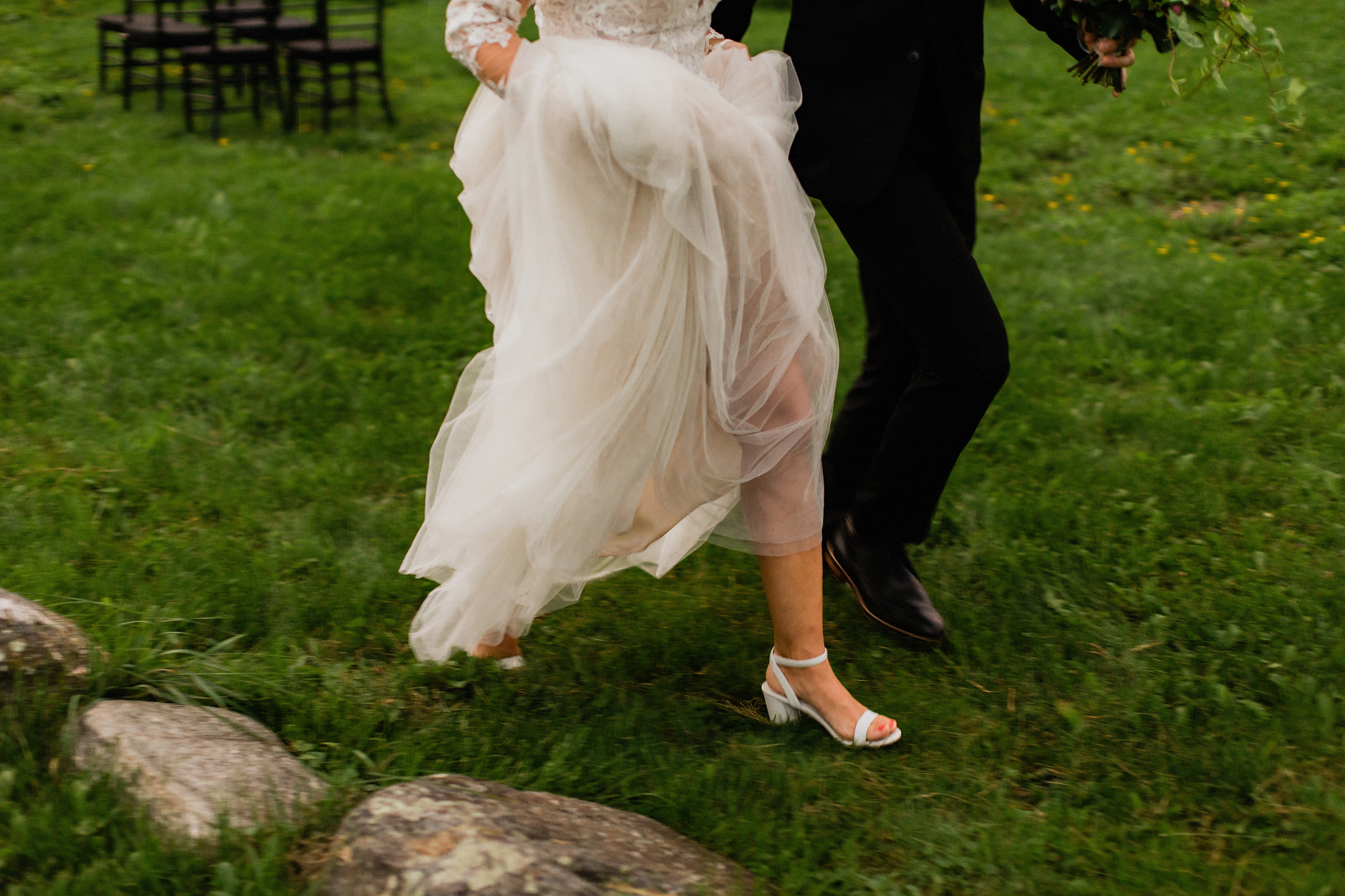 Bride and groom run to beat the rain at Coffin Ridge Boutique Wi